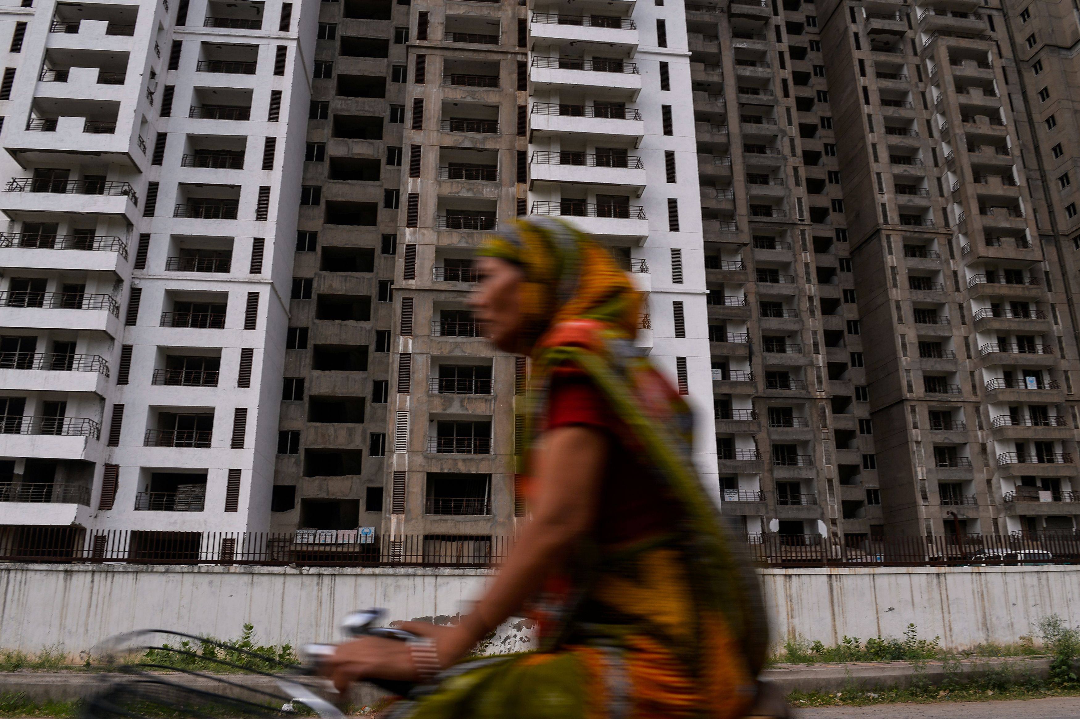 A cyclist rides past incomplete residential apartments in Greater Noida. India’s property market is seeing a resurgence after years of stagnating prices and unsold inventory. Photo: AFP
