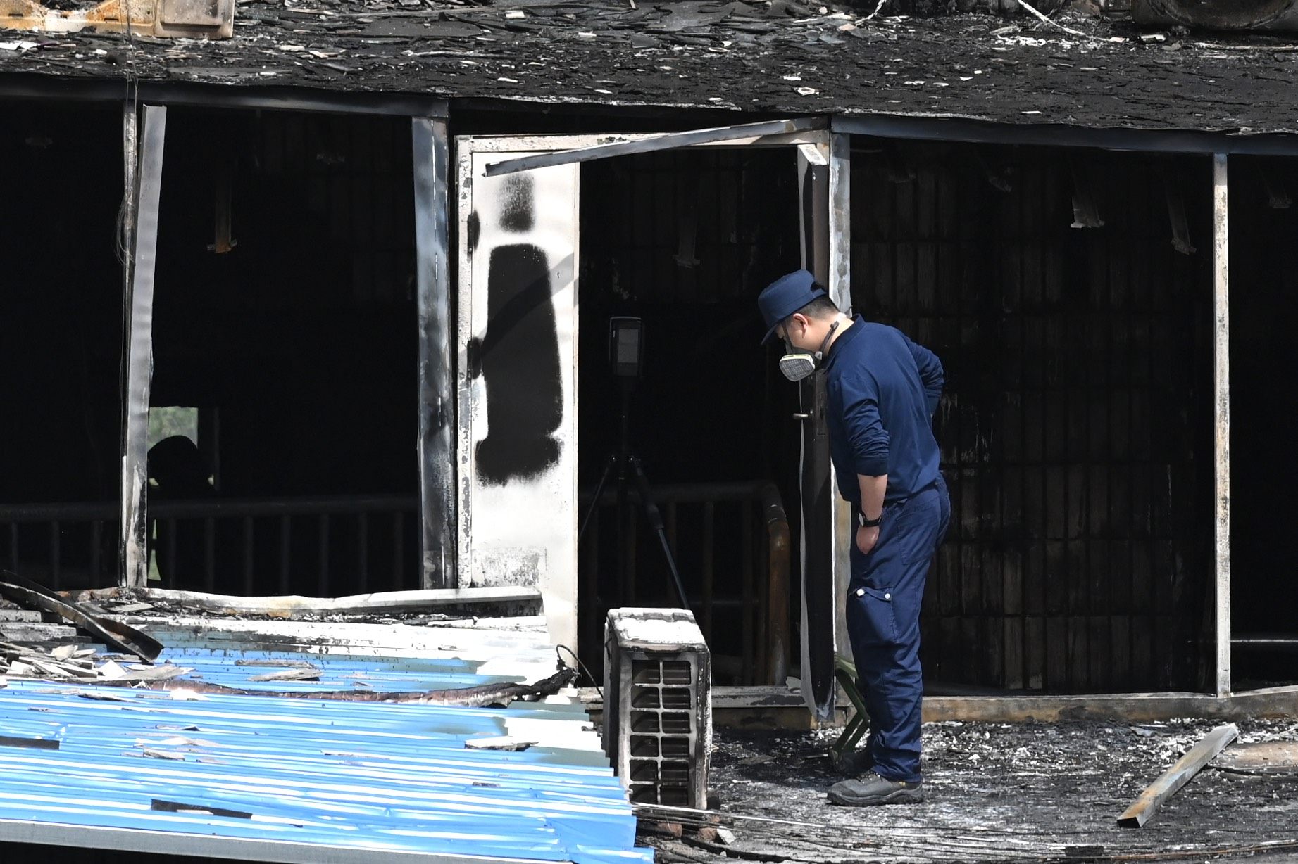 An investigator surveys fire damage at the Changfeng Hospital in Beijing, where 29 people died on Tuesday. Photo: AFP