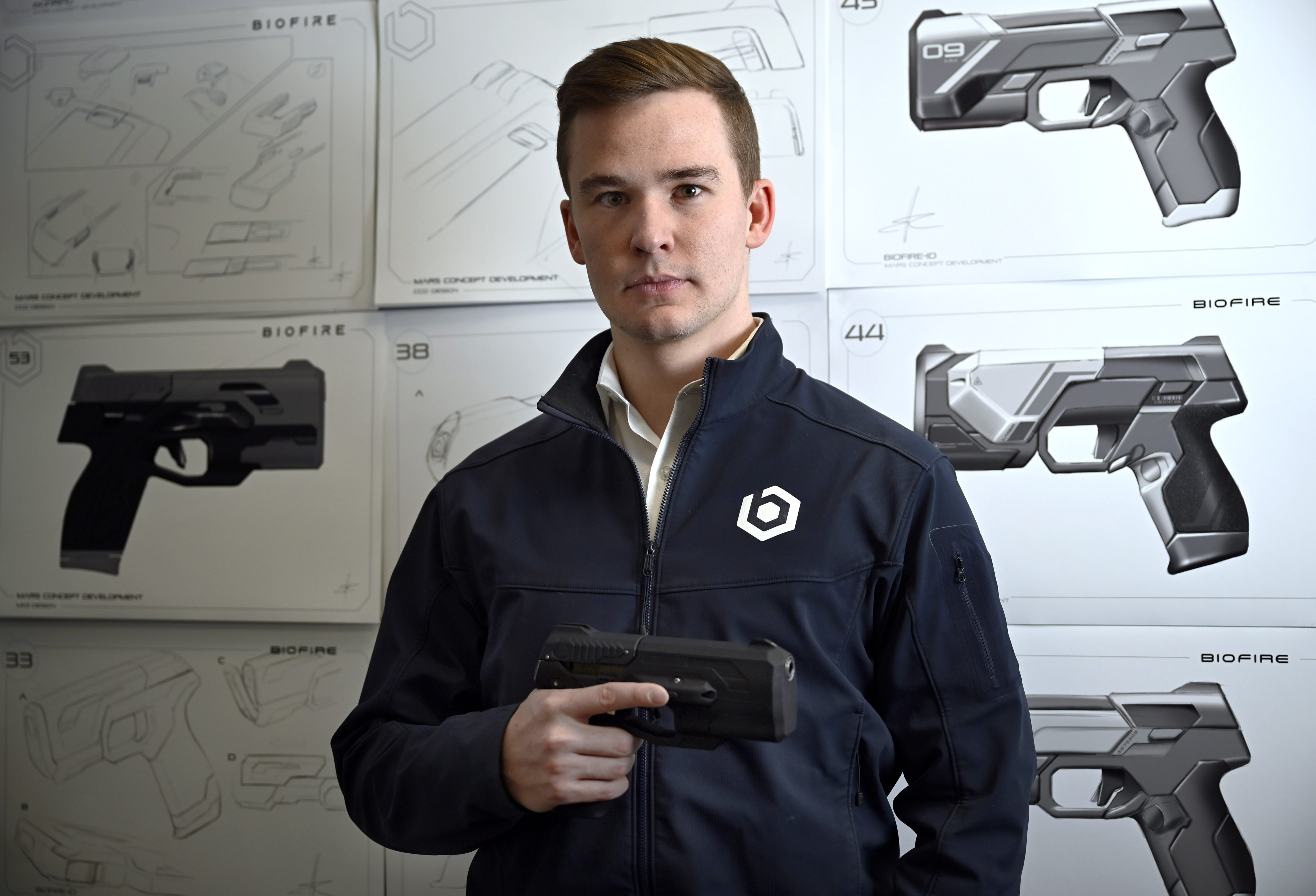 Kai Kloepfer, the founder and CEO of US ‘smart gun’ manufacturer Biofire Tech, stands in front of product drawings at the company’s headquarters in Colorado. Photo: TNS