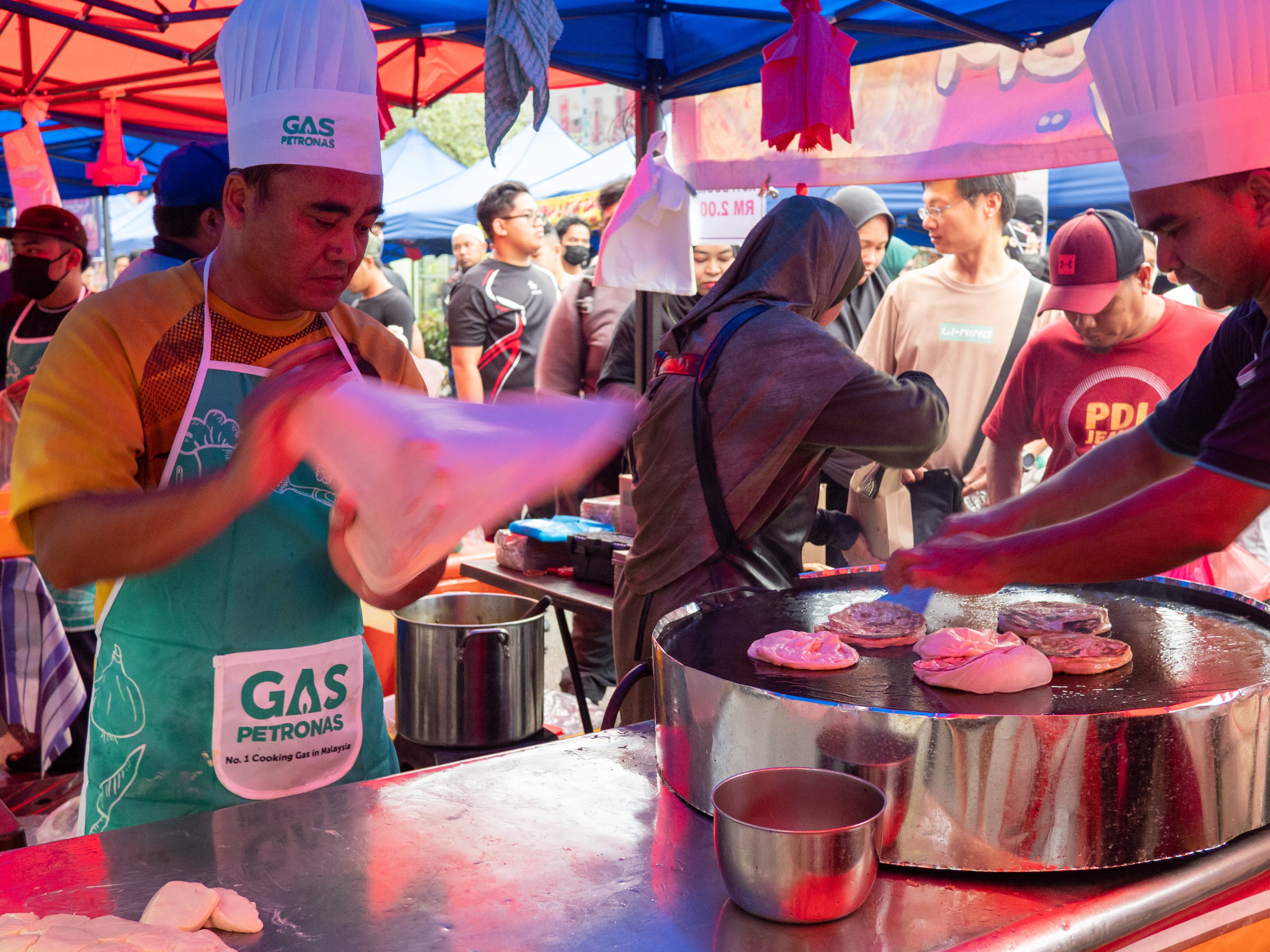 A Ramadan bazaar seller flipping roti canai at the Kampung Baru Ramadan bazaar in Kuala Lumpur.  Photo: SCMP / Hadi Azmi