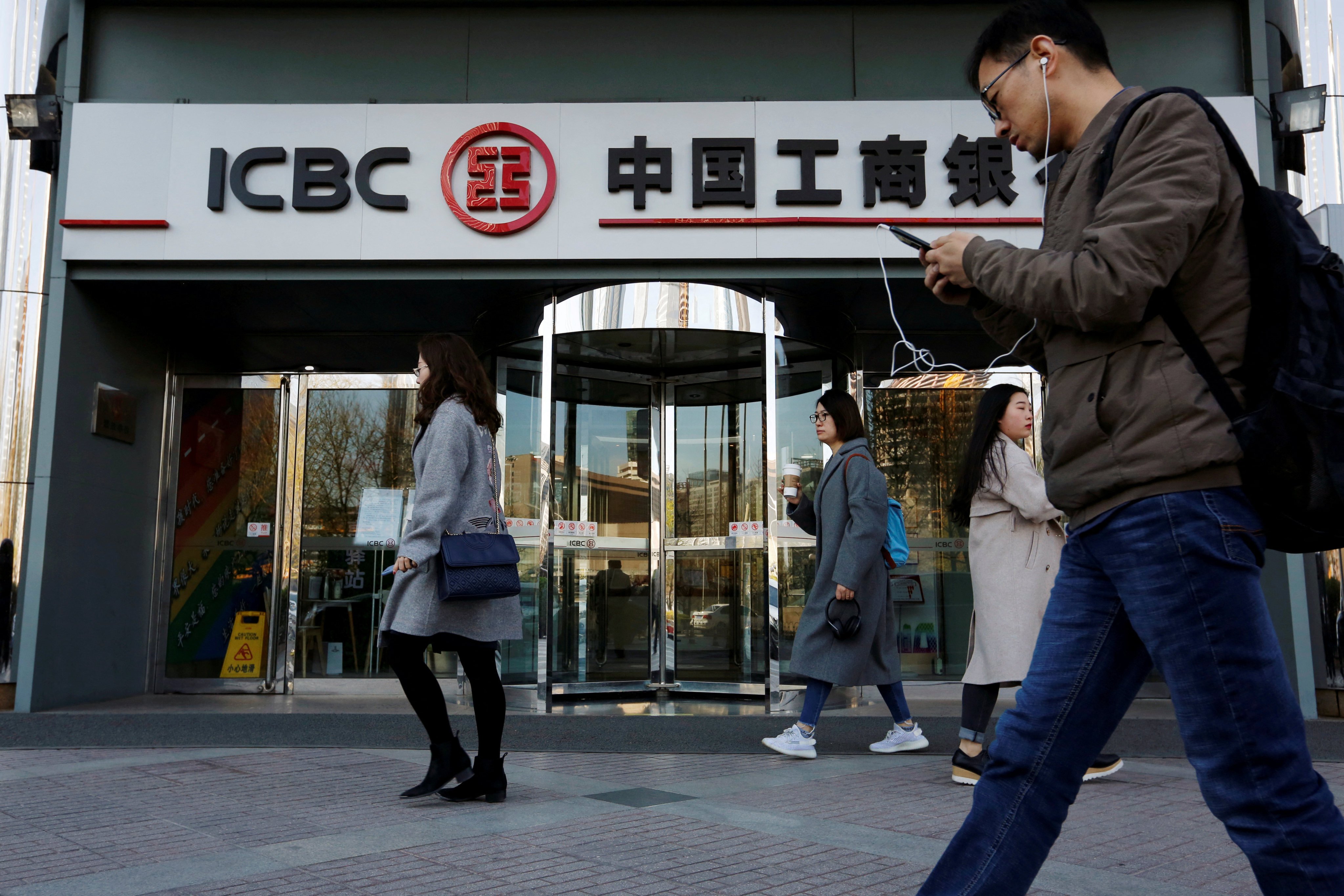 People walk past a branch of Industrial and Commercial Bank of China (ICBC) in Beijing in April 2019. Photo: Reuters