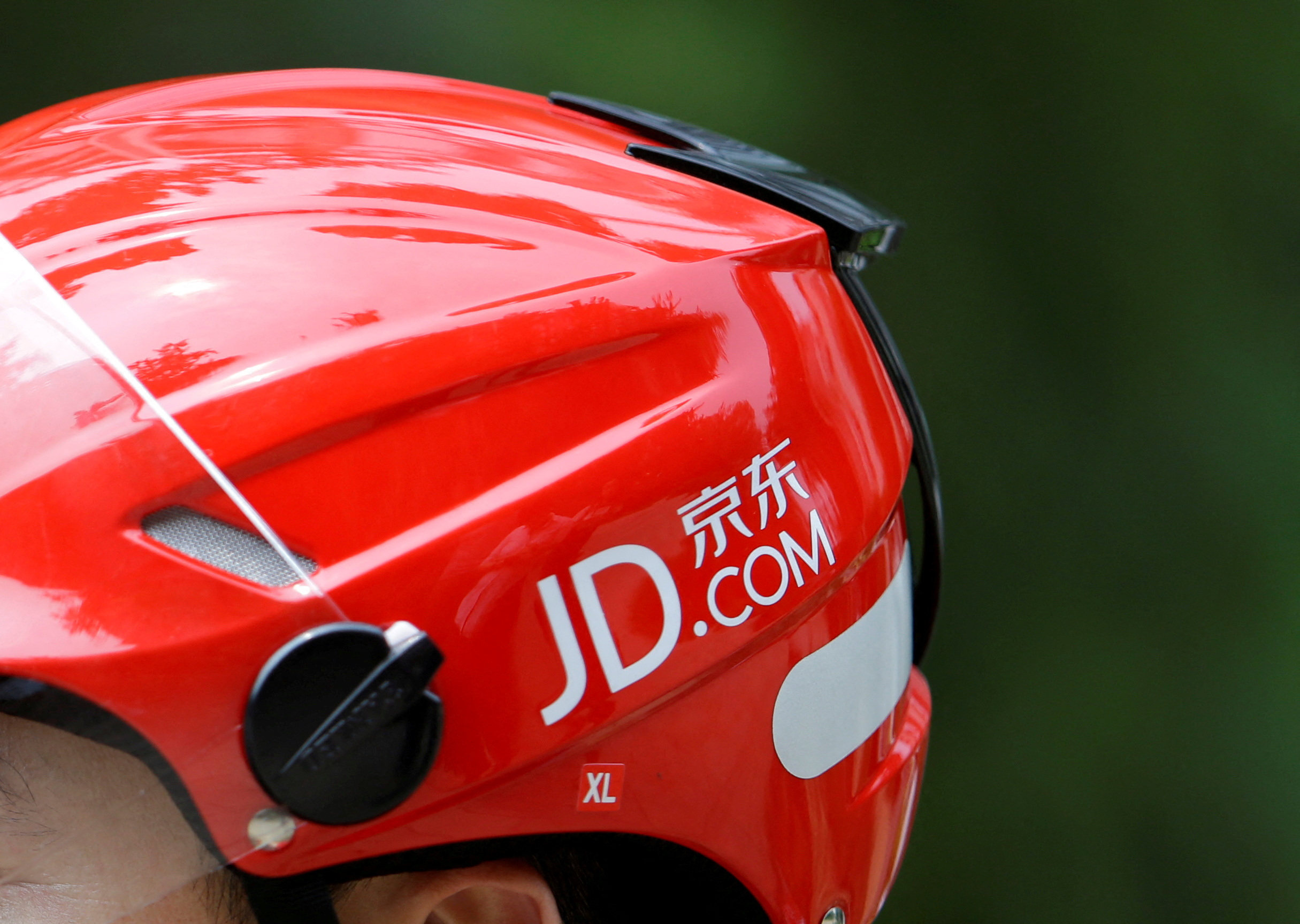 The logo of JD.com seen on a helmet of a delivery rider in Beijing on June 16, 2014. Photo: Reuters