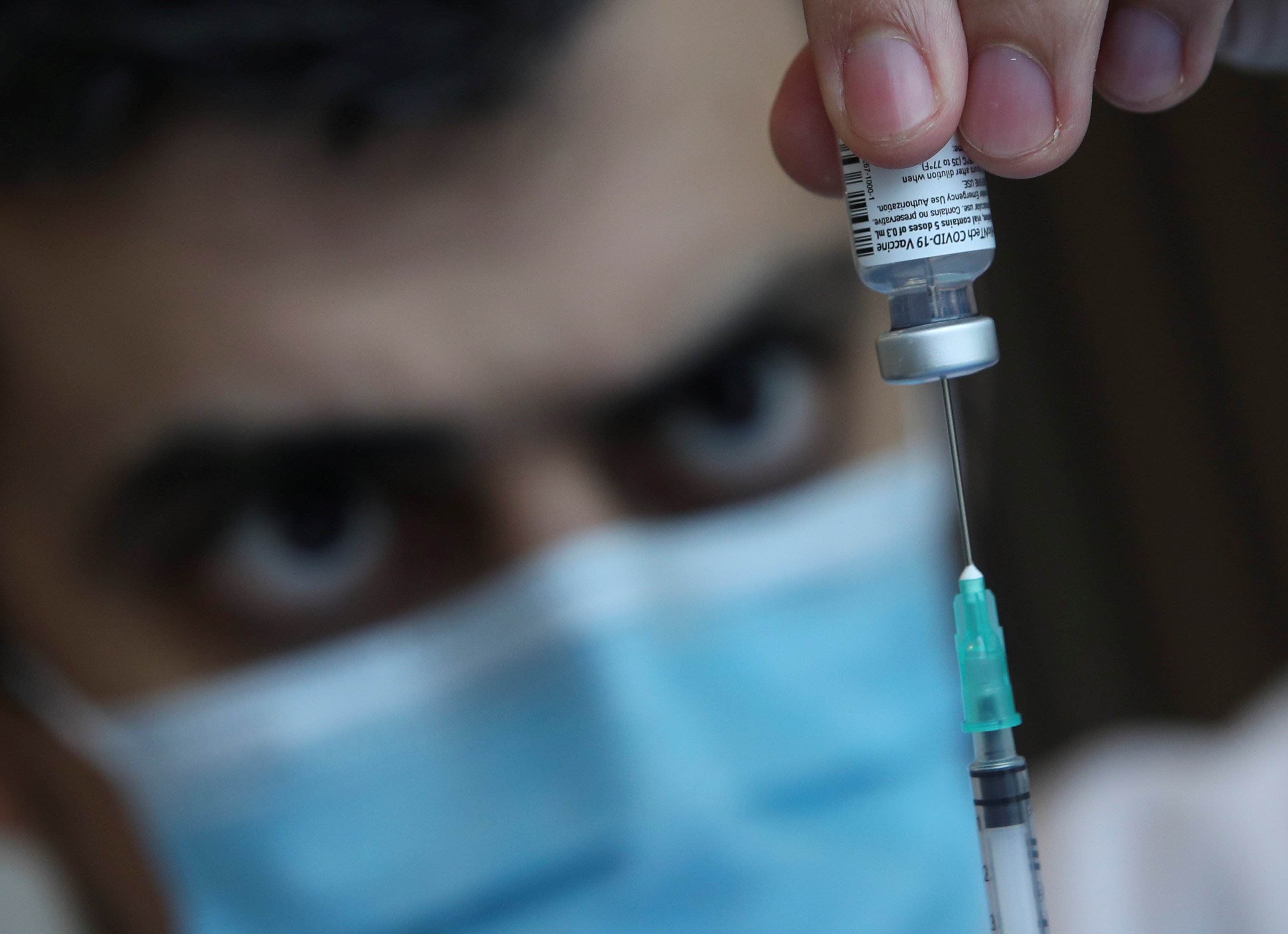 A medical worker fills a syringe with a Pfizer-BioNTech vaccine dose in Brussels. Photo: Reuters