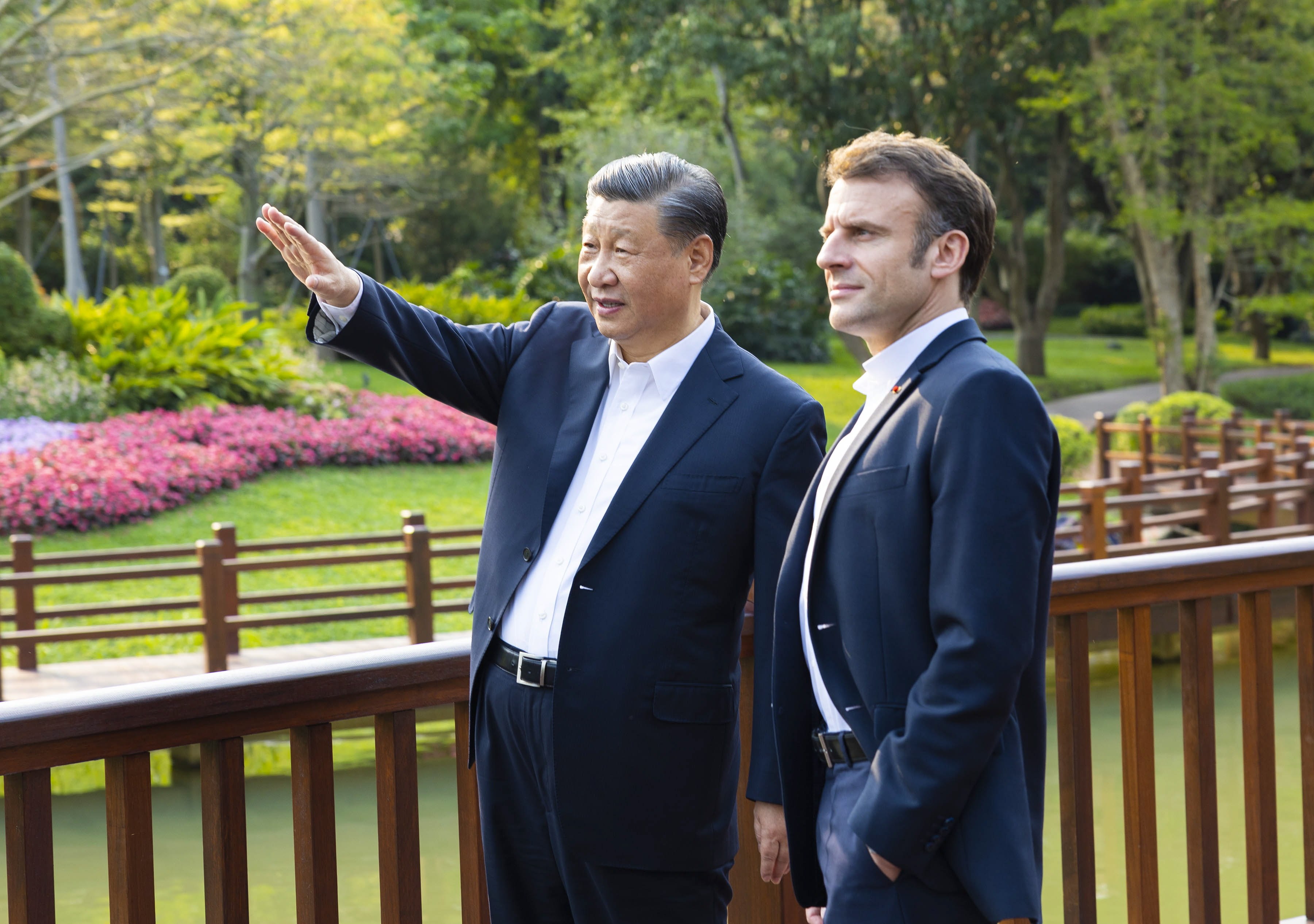 Chinese President Xi Jinping and French President Emmanuel Macron chat during a stroll through the Pine Garden in Guangzhou on April 7. Macron has alluded to to an unhealthy, even dangerous, trend in transatlantic relations. Photo: EPA-EFE/Xinhua