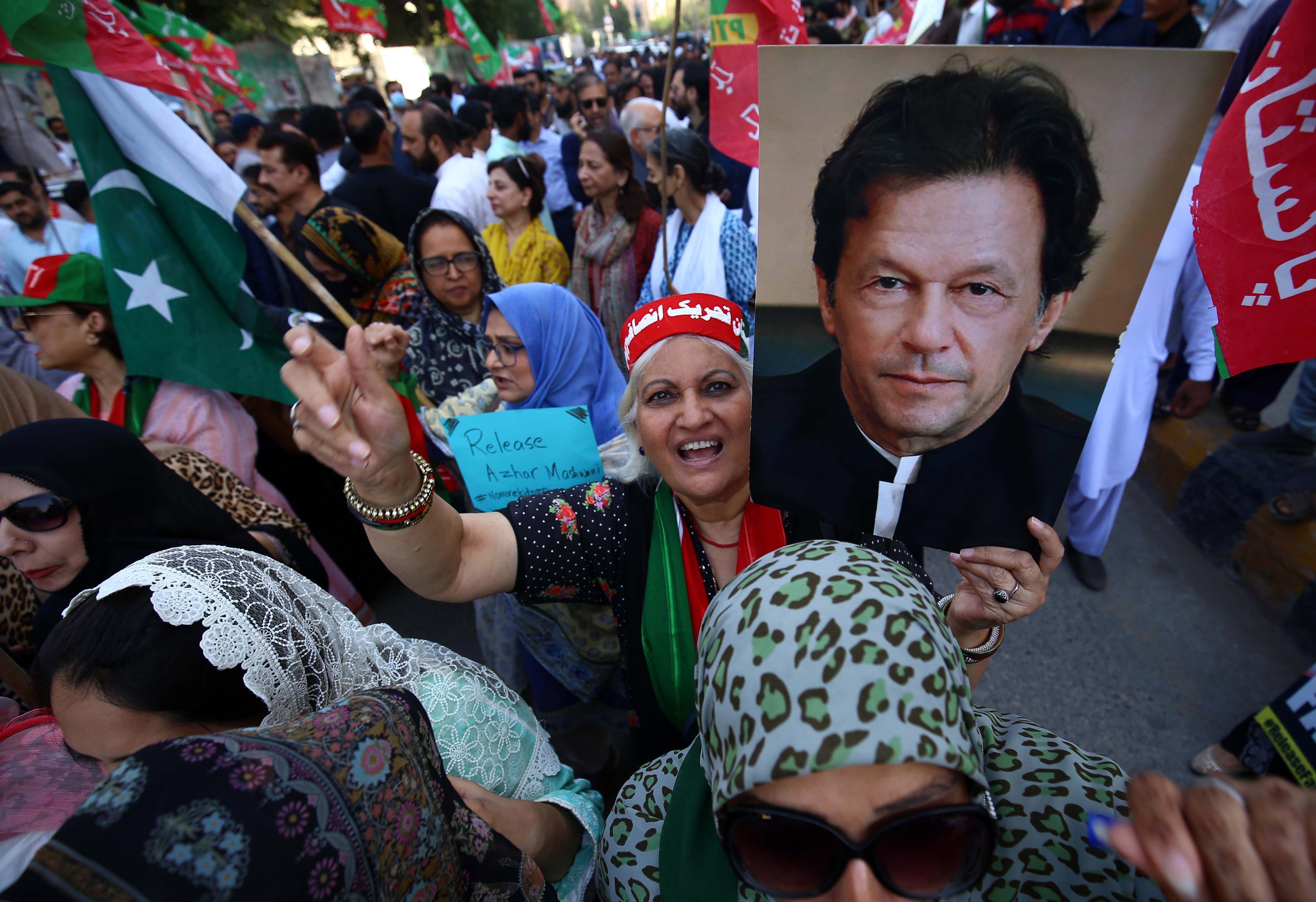 A supporter of opposition party Pakistan Tehreek-e-Insaf (PTI) holds a poster of its chairman Imran Khan, the nation’s former leader, during a rally in March. Photo: EPA-EFE