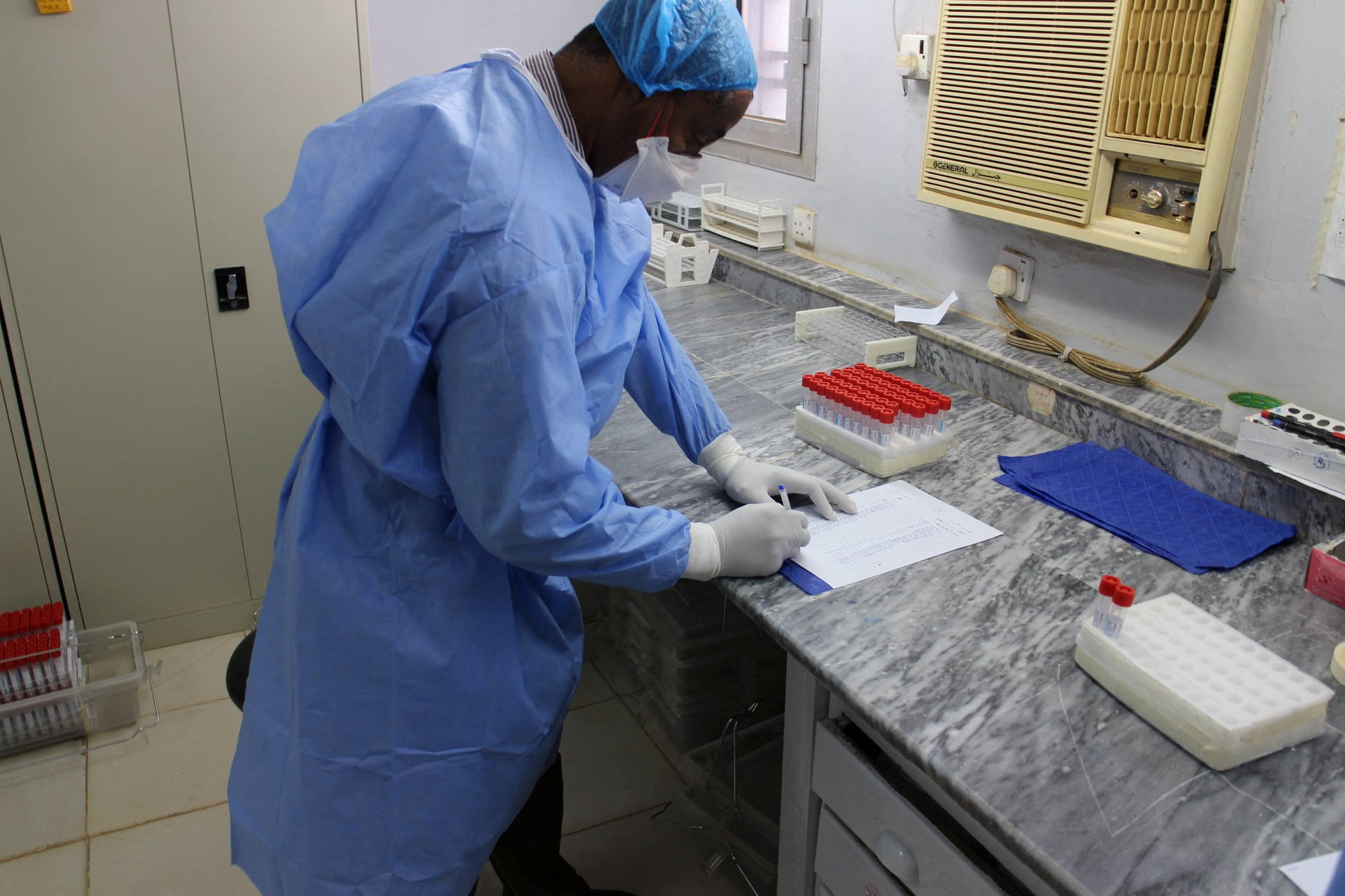 An undated photo shows a staff member at the National Public Health Laboratory in Khartoum, Sudan. Photo: Handout via Reuters