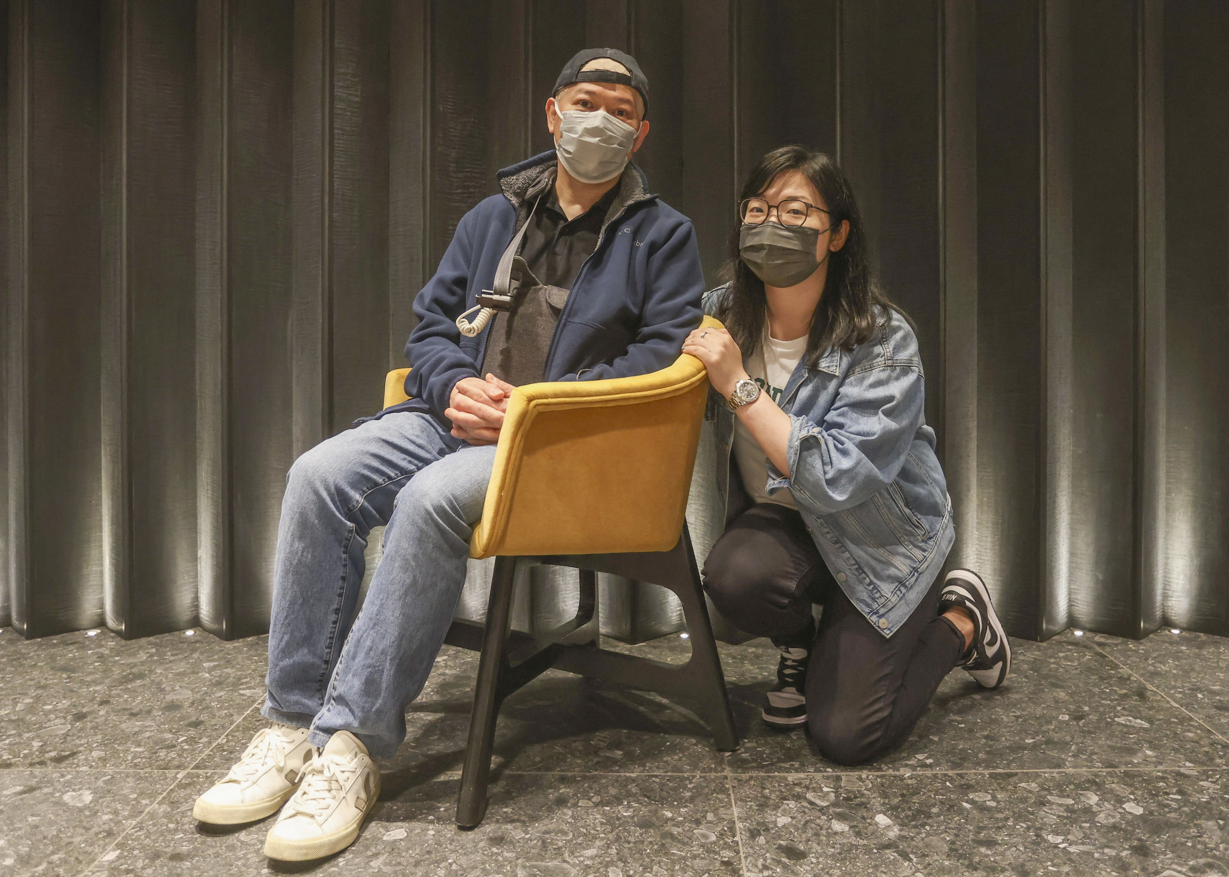 Brain cancer patient Leung King-yin with his daughter, Sharon. Leung, who is undergoing TTFields treatment, is wearing the TTFields cap under his baseball cap and is carrying the bag containing the cap’s battery pack. Photo: Jonathan Wong