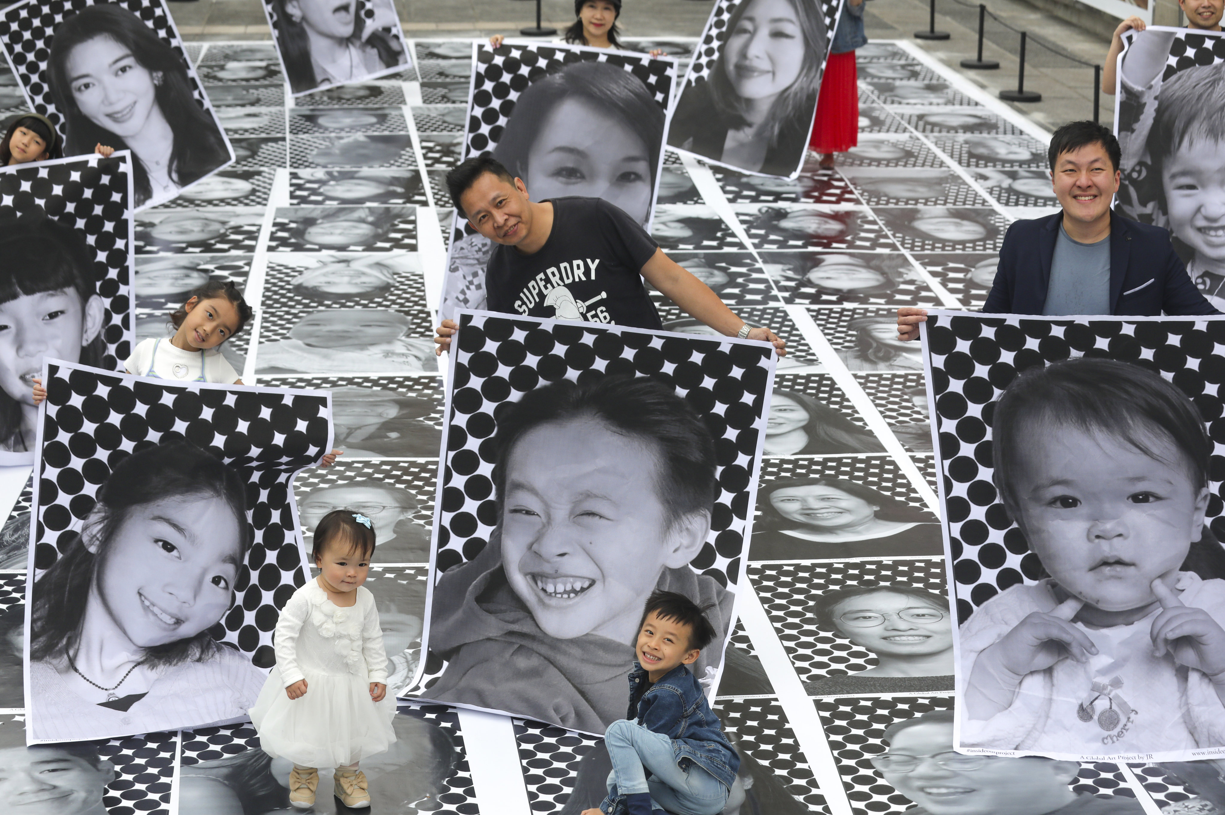 An art installation featuring black-and-white portraits outside Harbour City in Tsim Sha Tsui. Photo: Xiaomei Chen
