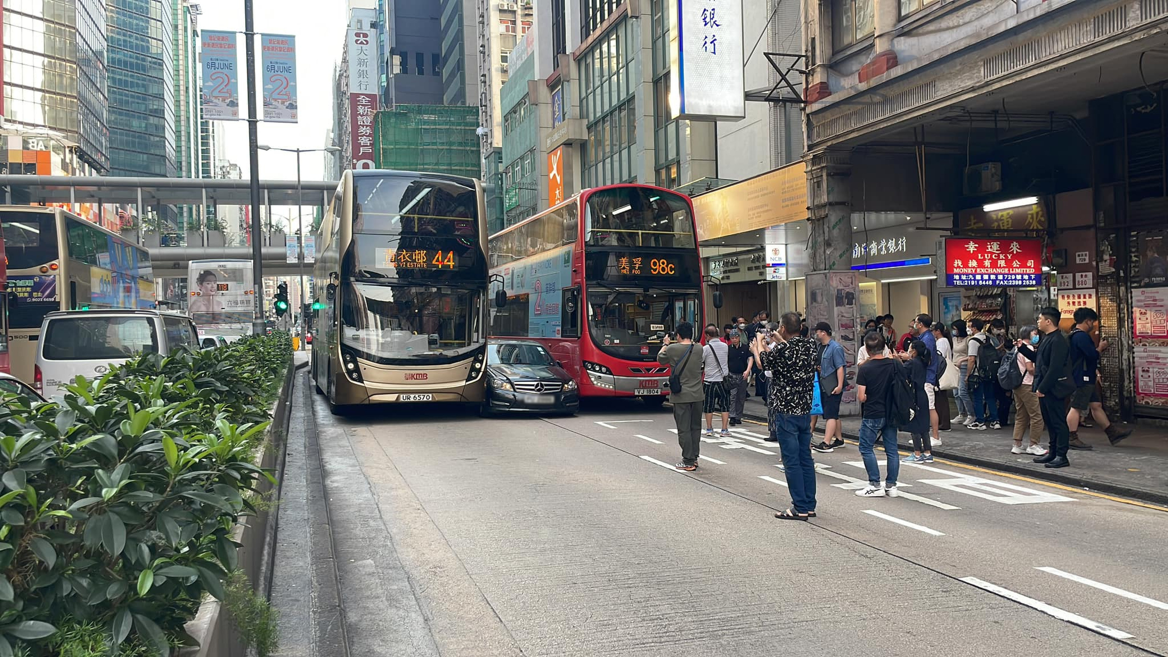 Passers-by capture a crash where a luxury Mercedes-Benz was sandwiched between to buses during Hong Kong’s rush hour. Photo: Facebook@Kam Adonis