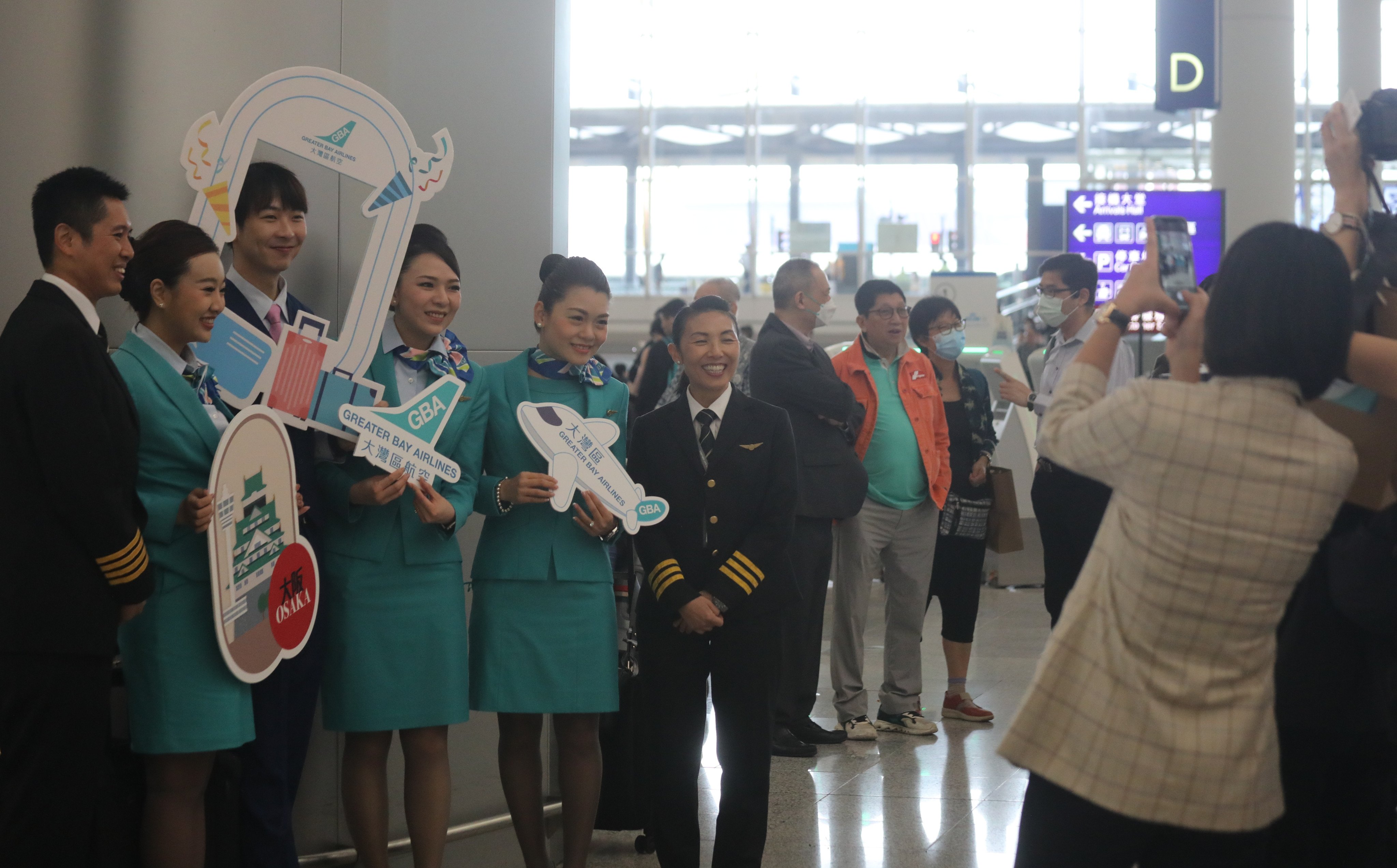 GBA crew members welcome passengers at the check in for the airline’s inaugural flight to Osaka in Japan. Photo: Xiaomei Chen
