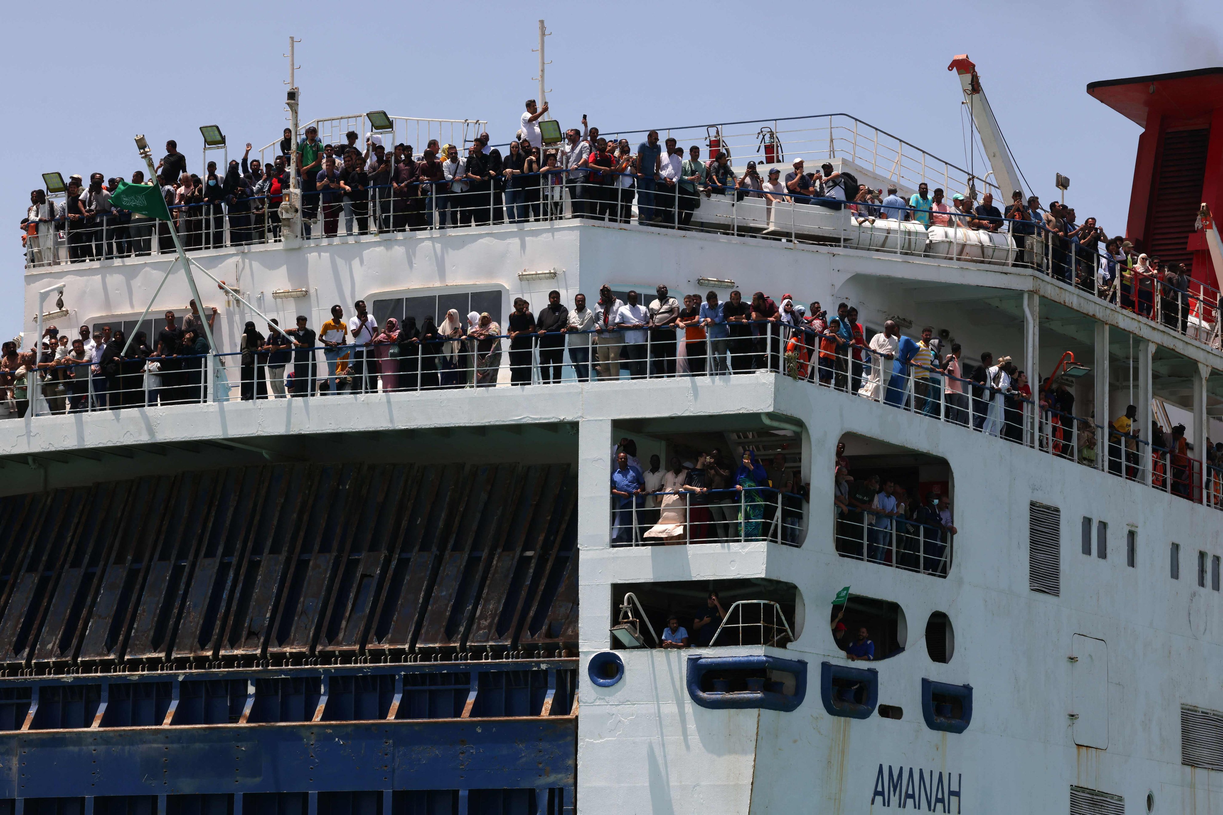 Evacuees stand on a ferry as it transports some 1,900 people across the Red Sea from Port Sudan to the Saudi King Faisal navy base in Jeddah. Photo: AFP