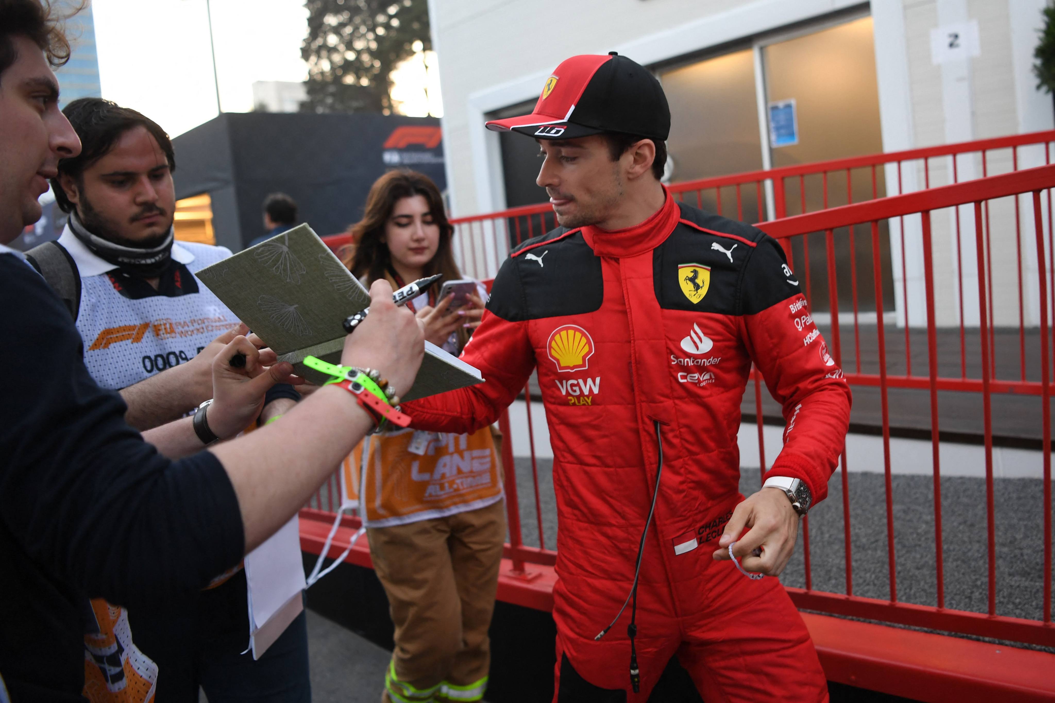 Ferrari’s Charles Leclerc signs autographs for fans after qualifying at the Formula One Azerbaijan Grand Prix at the Baku City Circuit. Photo: AFP