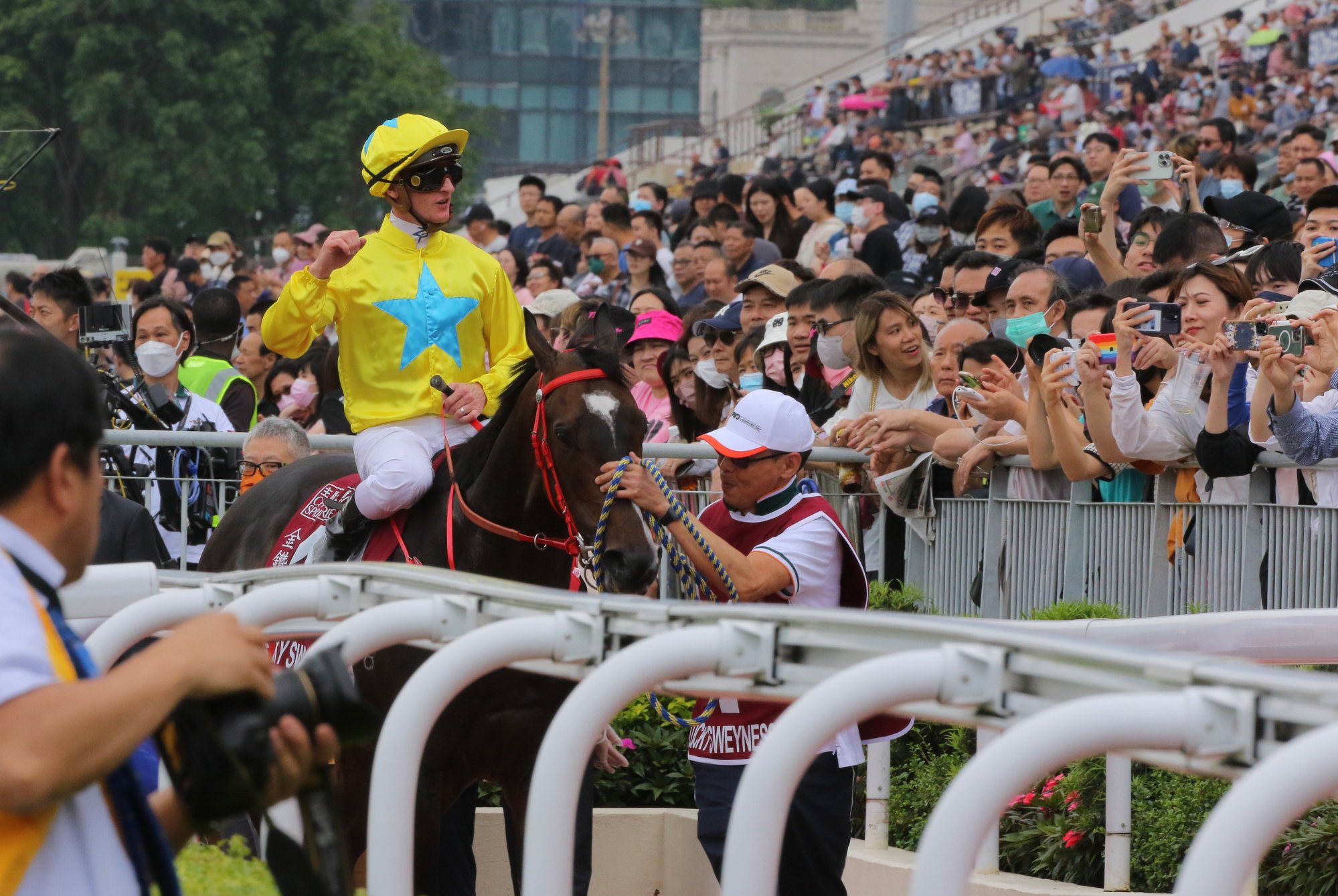 Zac Purton returns to the adulation of the Sha Tin crowd after saluting aboard Lucky Sweynesse on Sunday.