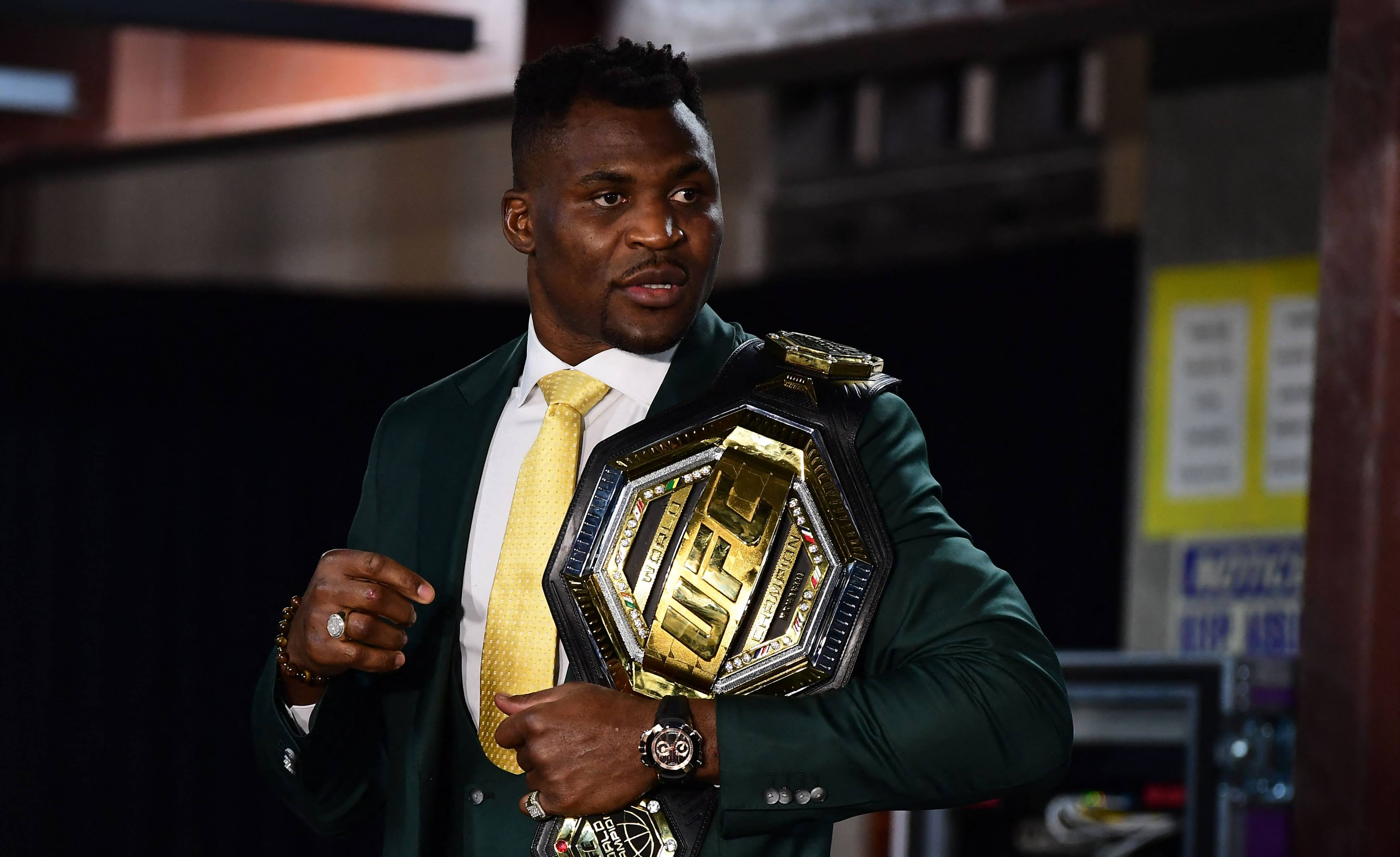 Francis Ngannou holds the UFC heavyweight title as he speaks to the media after defeating Ciryl Gane Gane at UFC 270. Photo: AFP