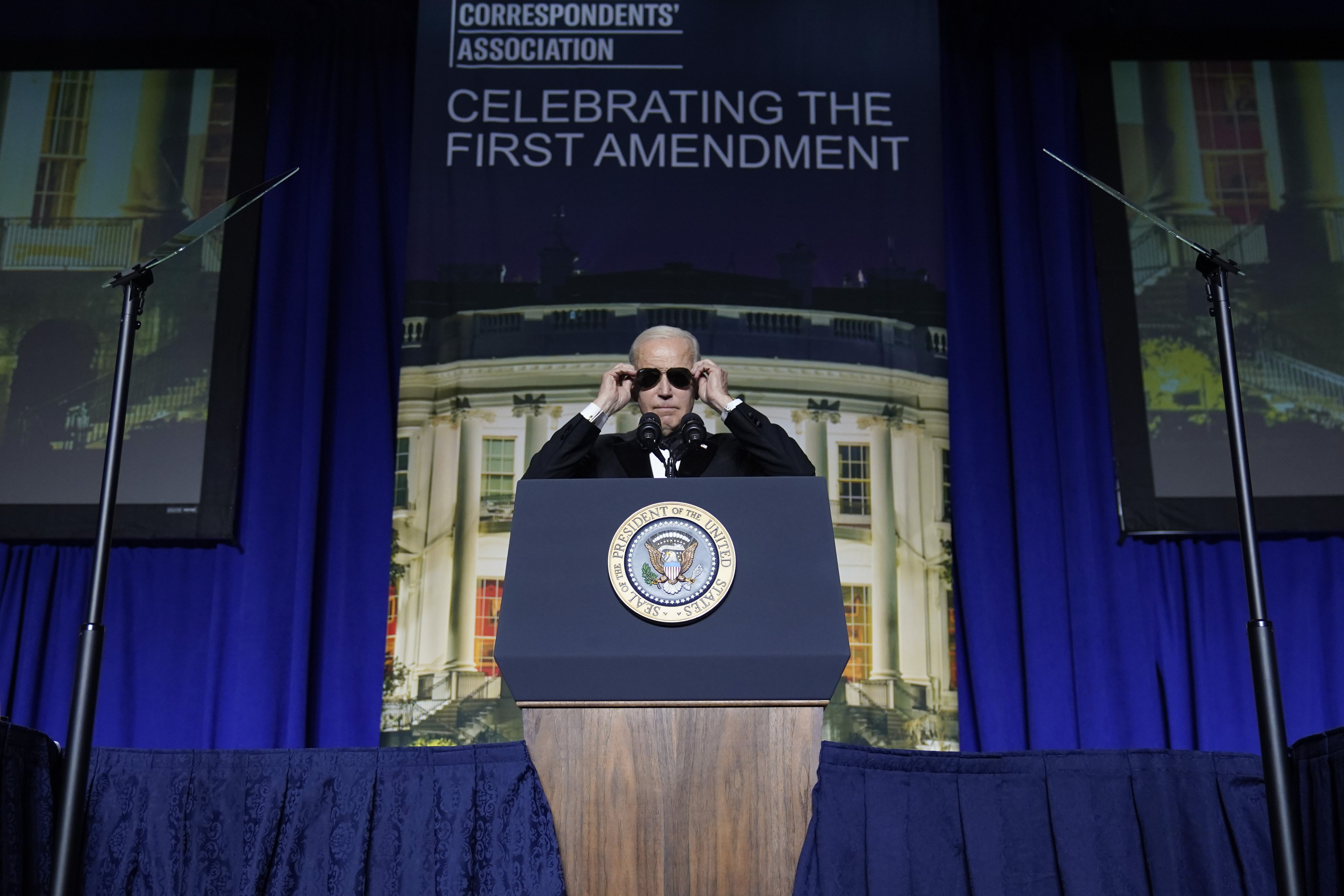 US President Joe Biden puts on sunglasses during the White House Correspondents’ Association dinner in Washington on Saturday. Photo: AP