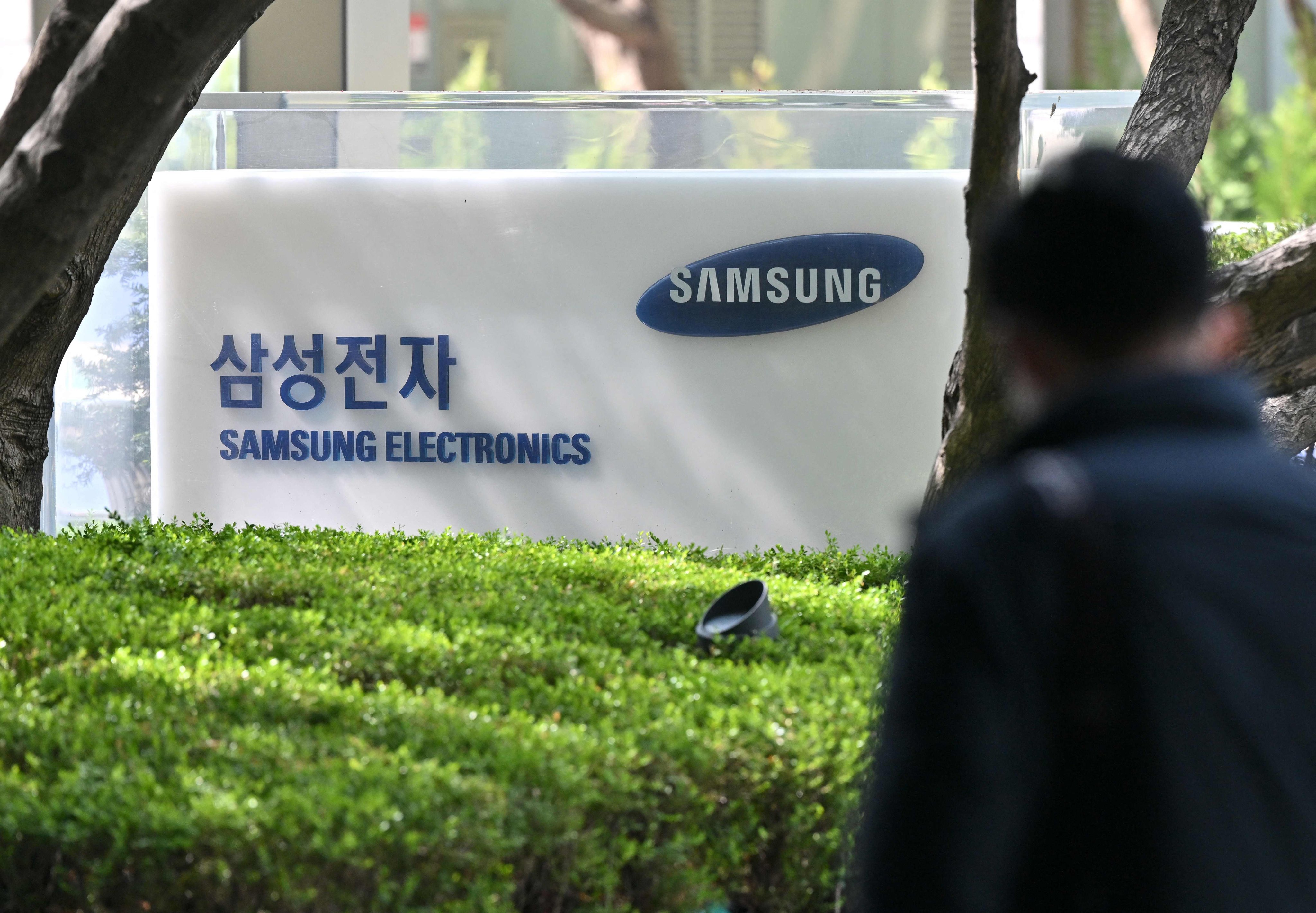 A man walks past a signboard of Samsung Electronics displayed outside the company’s Seocho building in Seoul on April 7, 2023. Photo: AFP