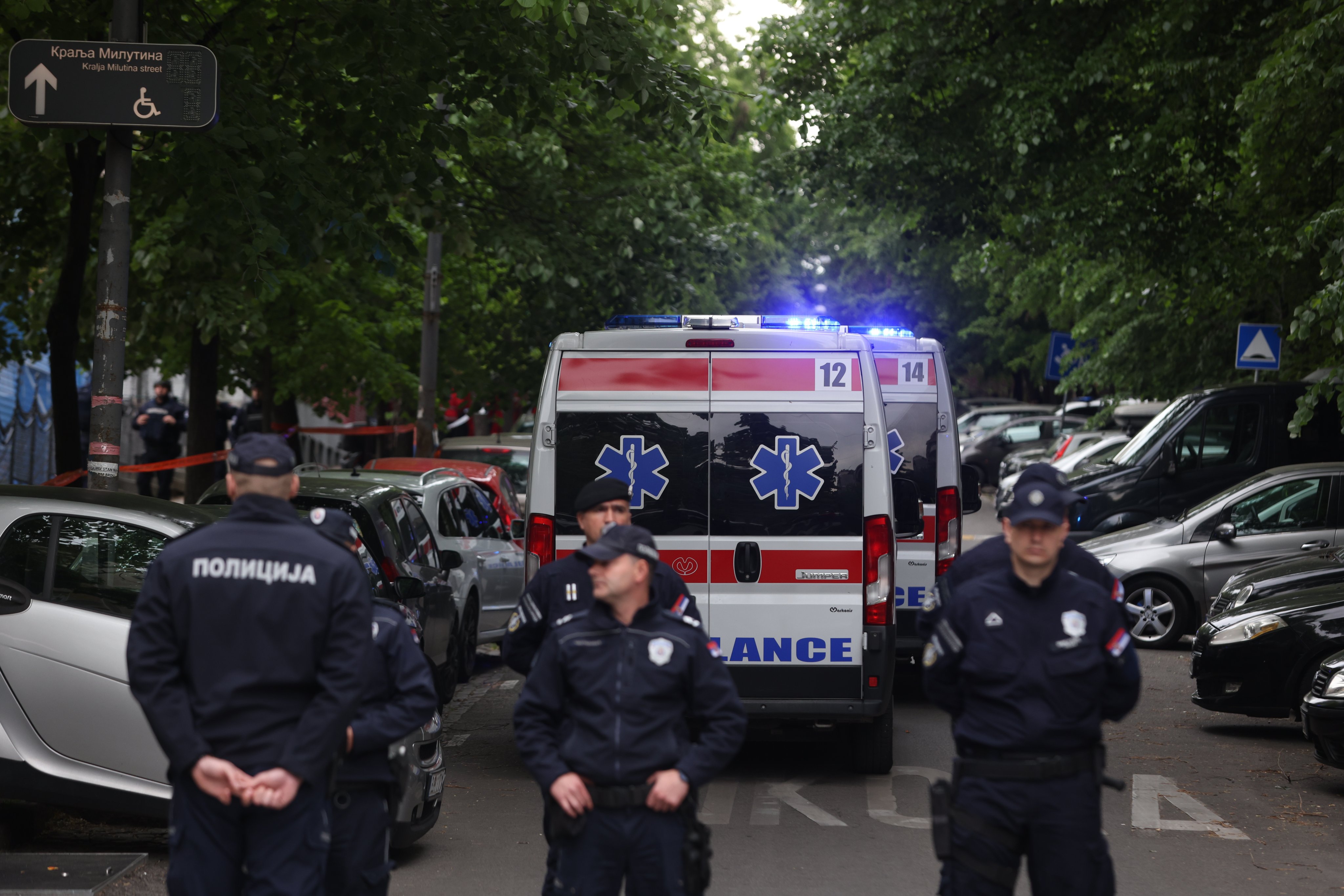 Ambulance arrive at the site as police officers block a street near the Vladislav Ribnikar elementary school in Belgrade. Photo: EPA-EFE