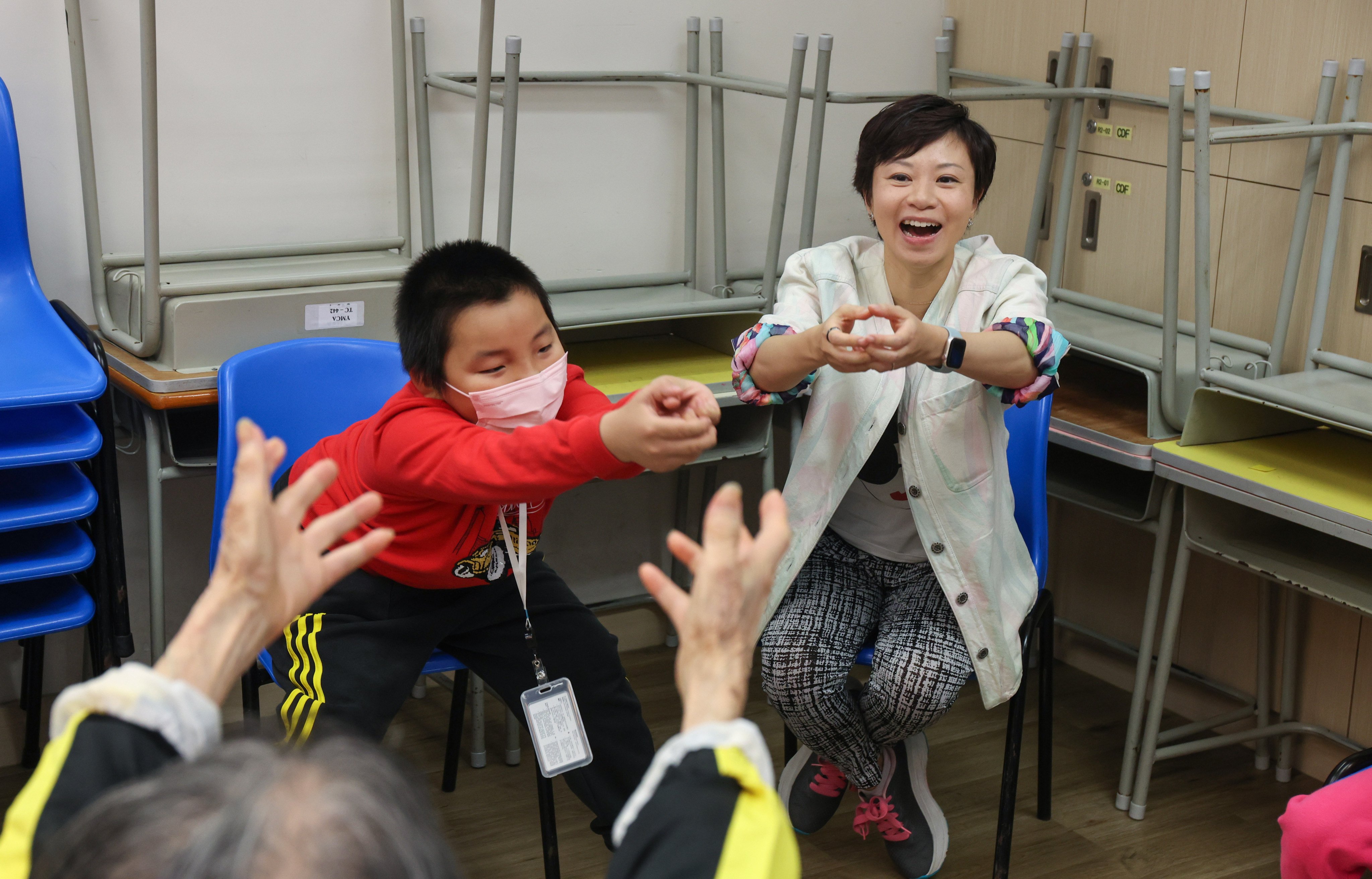 Cancer survivor and laughter yoga instructor Vincy Chau encourages students to laugh in Tung Chung, Hong Kong. Laughter has a variety of mental and physical health benefits. Photo: Edmond So