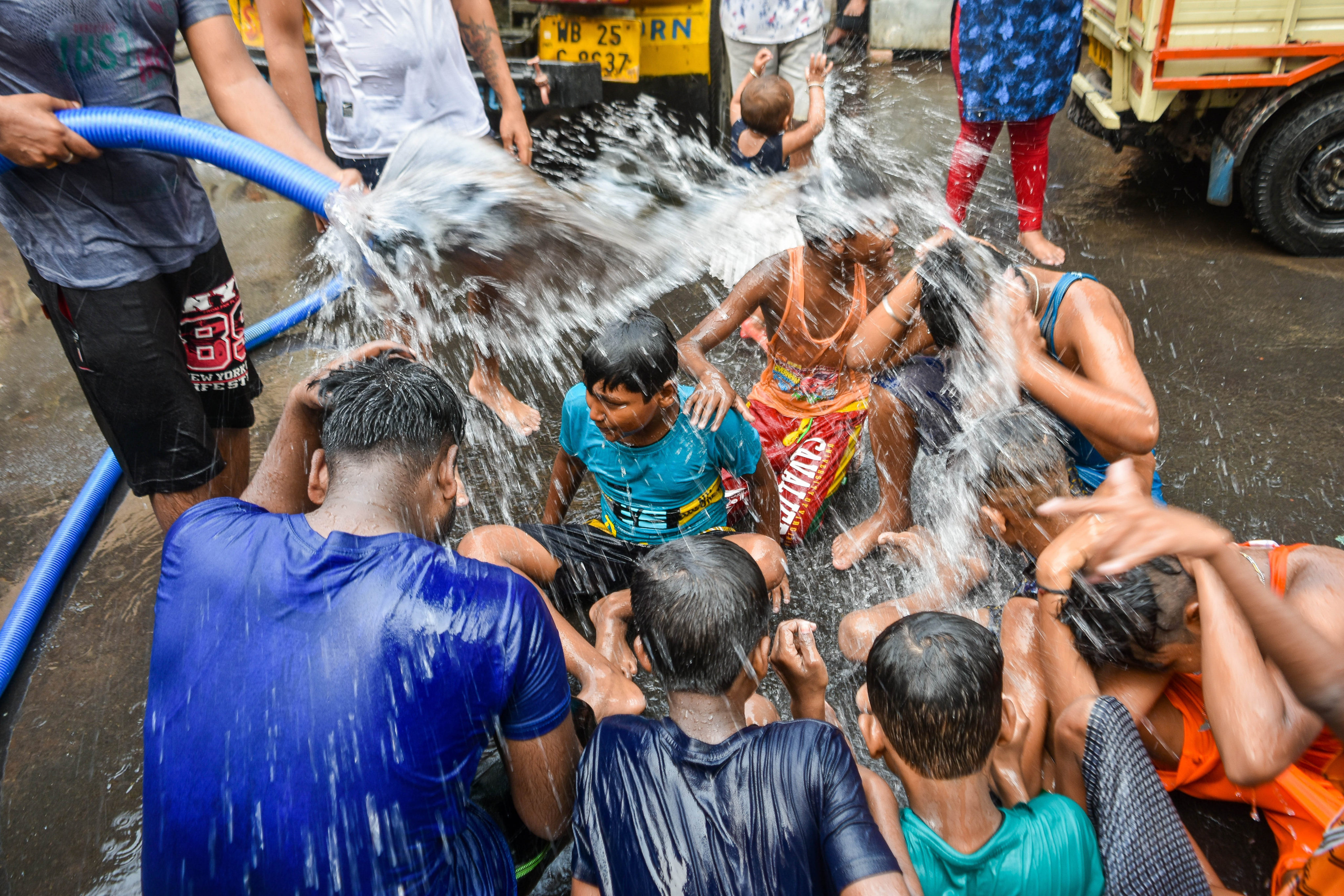 People cool down under a hose from a municipal tanker during a heatwave in Kolkata, India, on April 15. Since 2000, more than 40 per cent of the world’s climate-related disasters have occurred in the Asia-Pacific region. Photo: ZUMA Press Wire/dpa