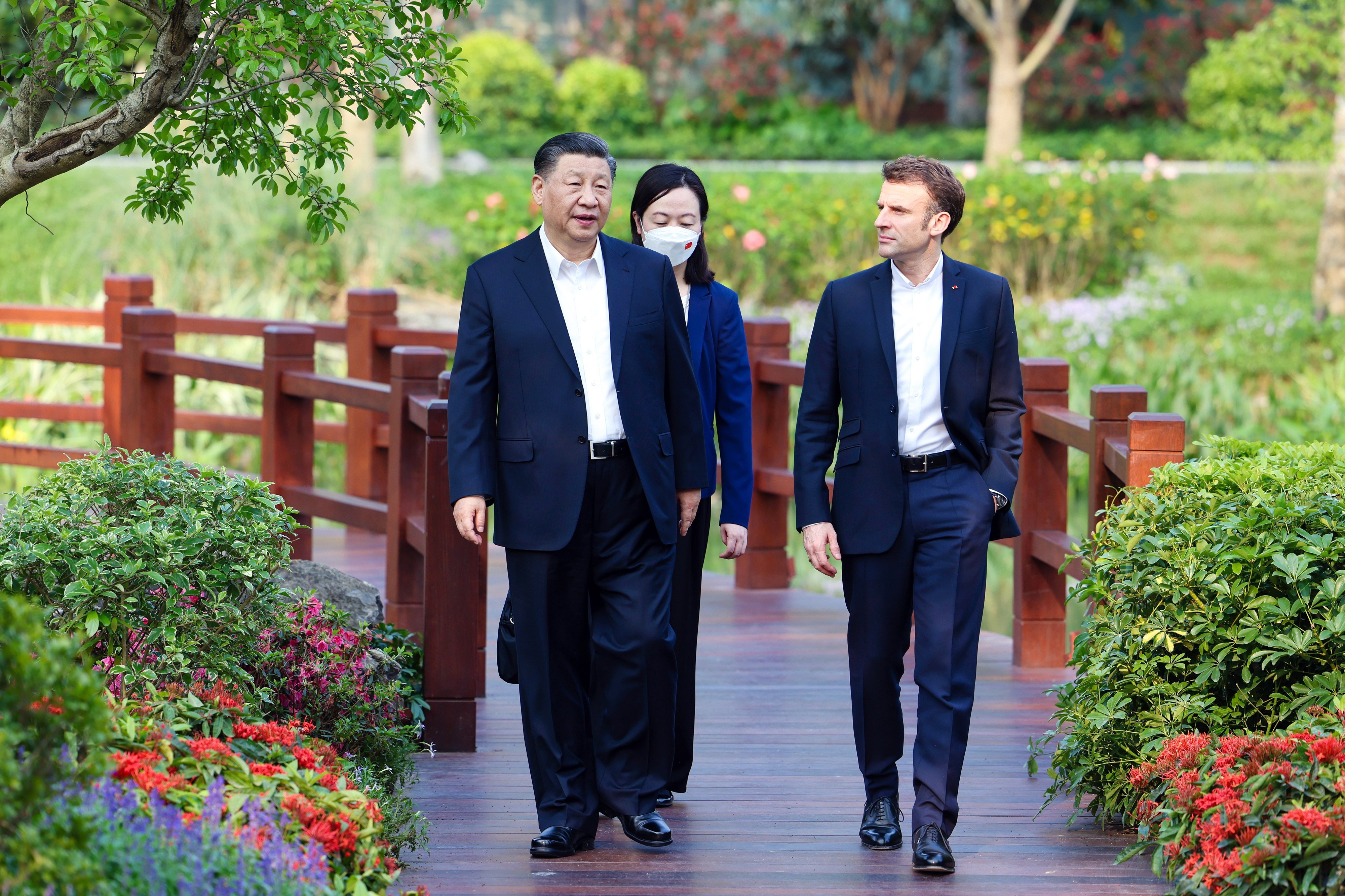President Xi Jinping (left) and French President Emmanuel Macron chat during a stroll through the Pine Garden in Guangzhou on April 7. Photo: EPA-EFE