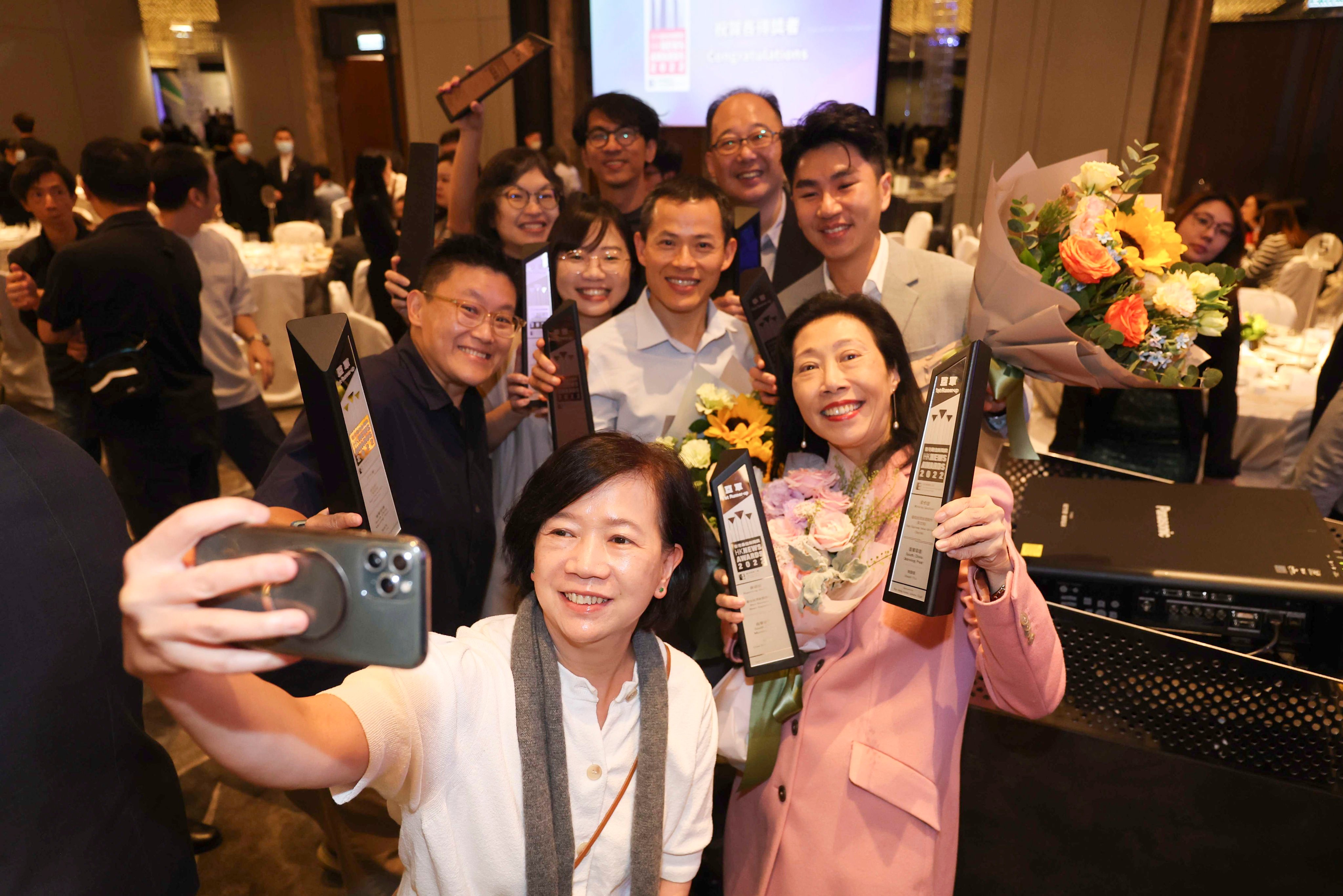 Journalists from the South China Morning Post celebrate their success at the 2022 Hong Kong News Awards. Photo: Edmond So
