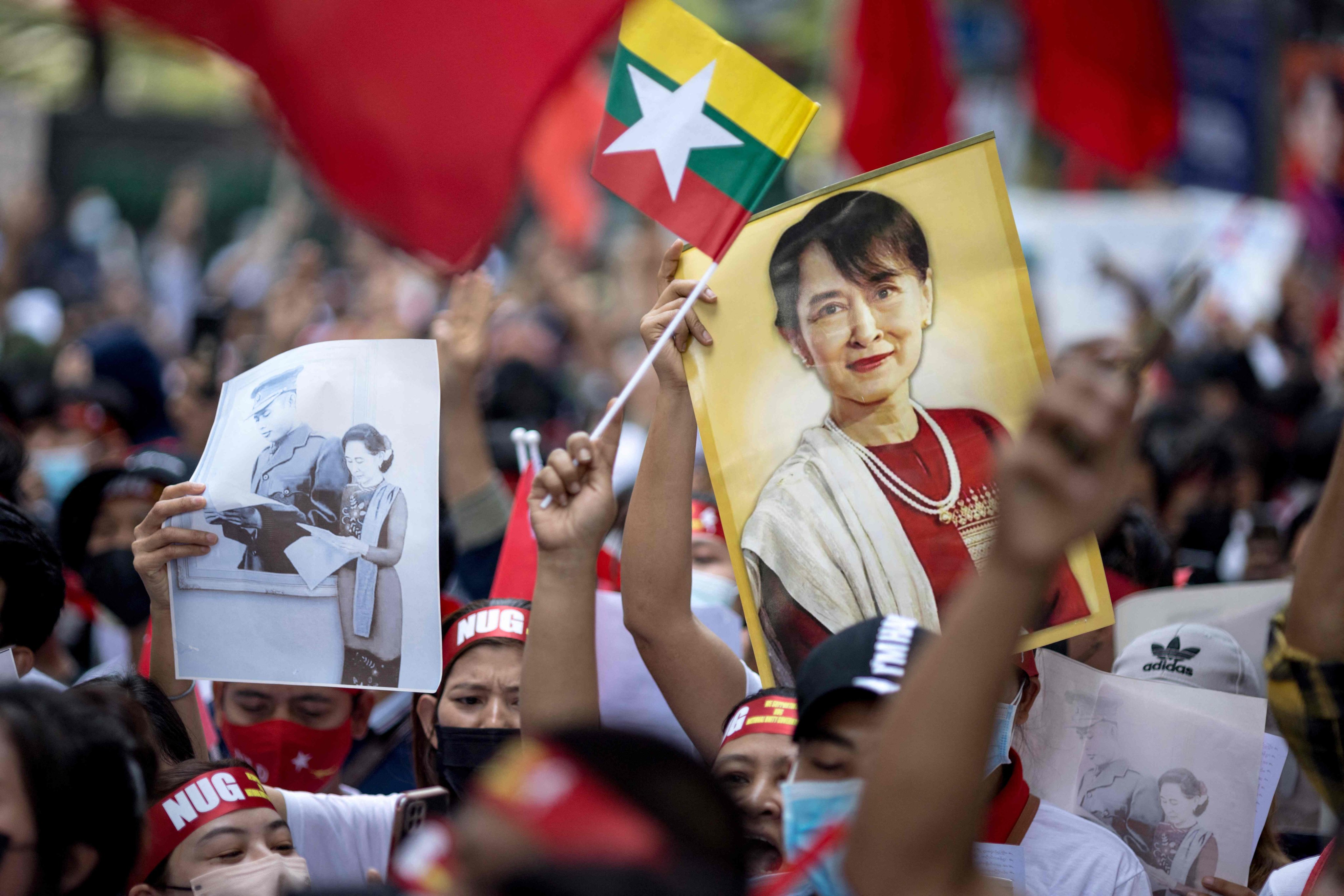Protesters hold images of detained civilian leader Aung San Suu Kyi and a flag of Myanmar during a demonstration in Bangkok on February 1 to mark the second anniversary of the coup. Photo: AFP