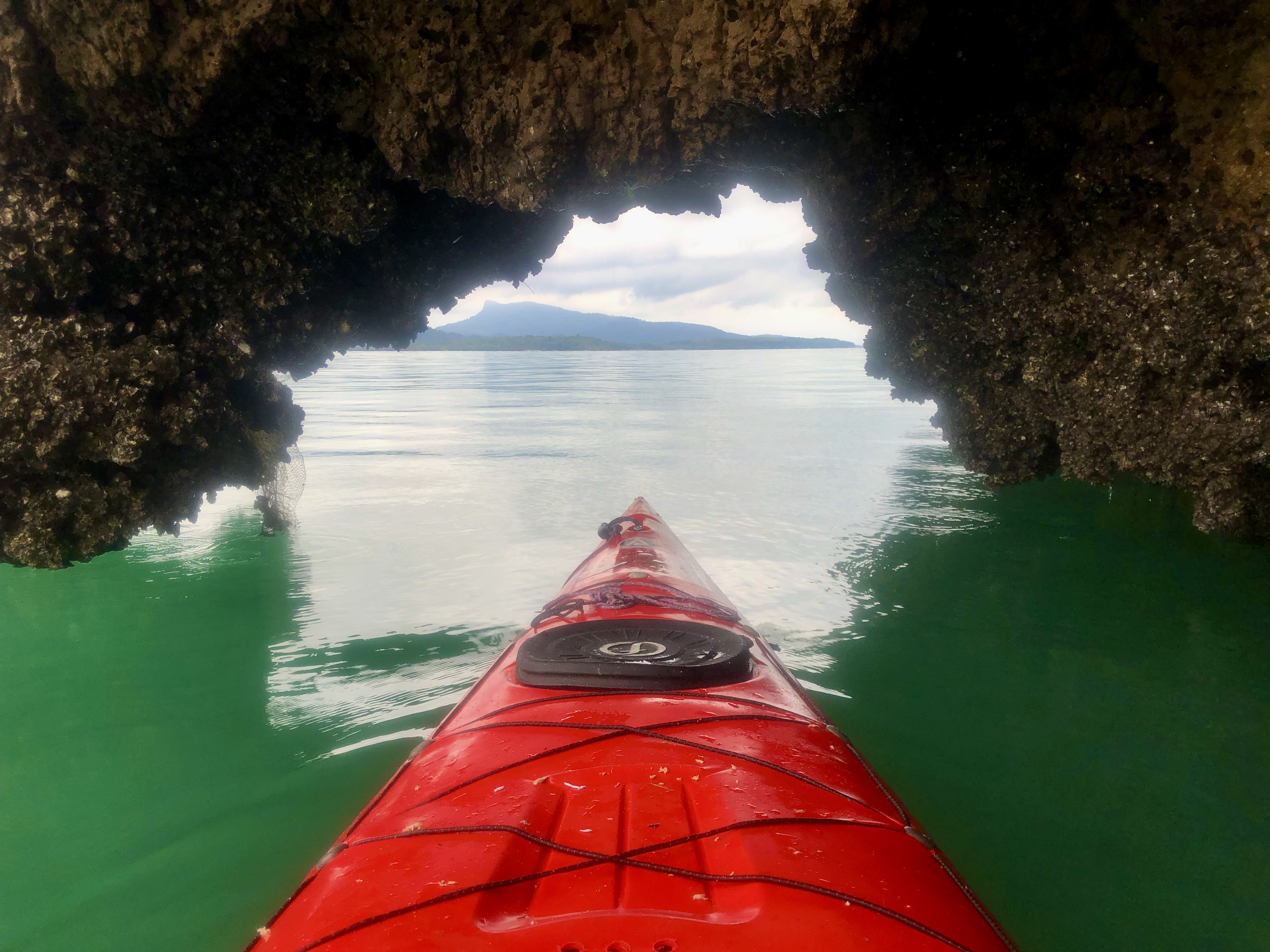 Caves honeycomb the base of karst rock formations at Phang Nga Bay, and many can be explored by kayak. Photo: Ian Neubauer