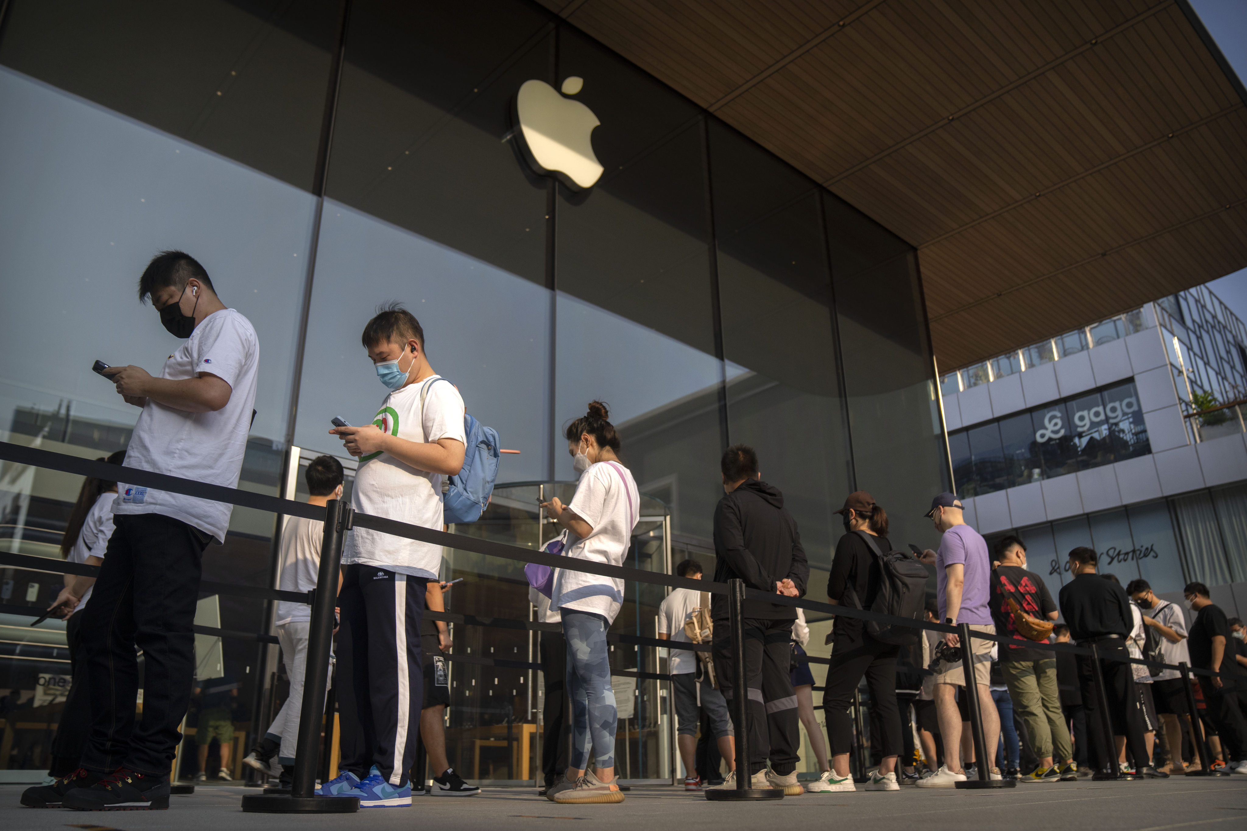 Customers line up outside an Apple Store in Beijing on the first day of sales for the iPhone 14. Photo: AP
