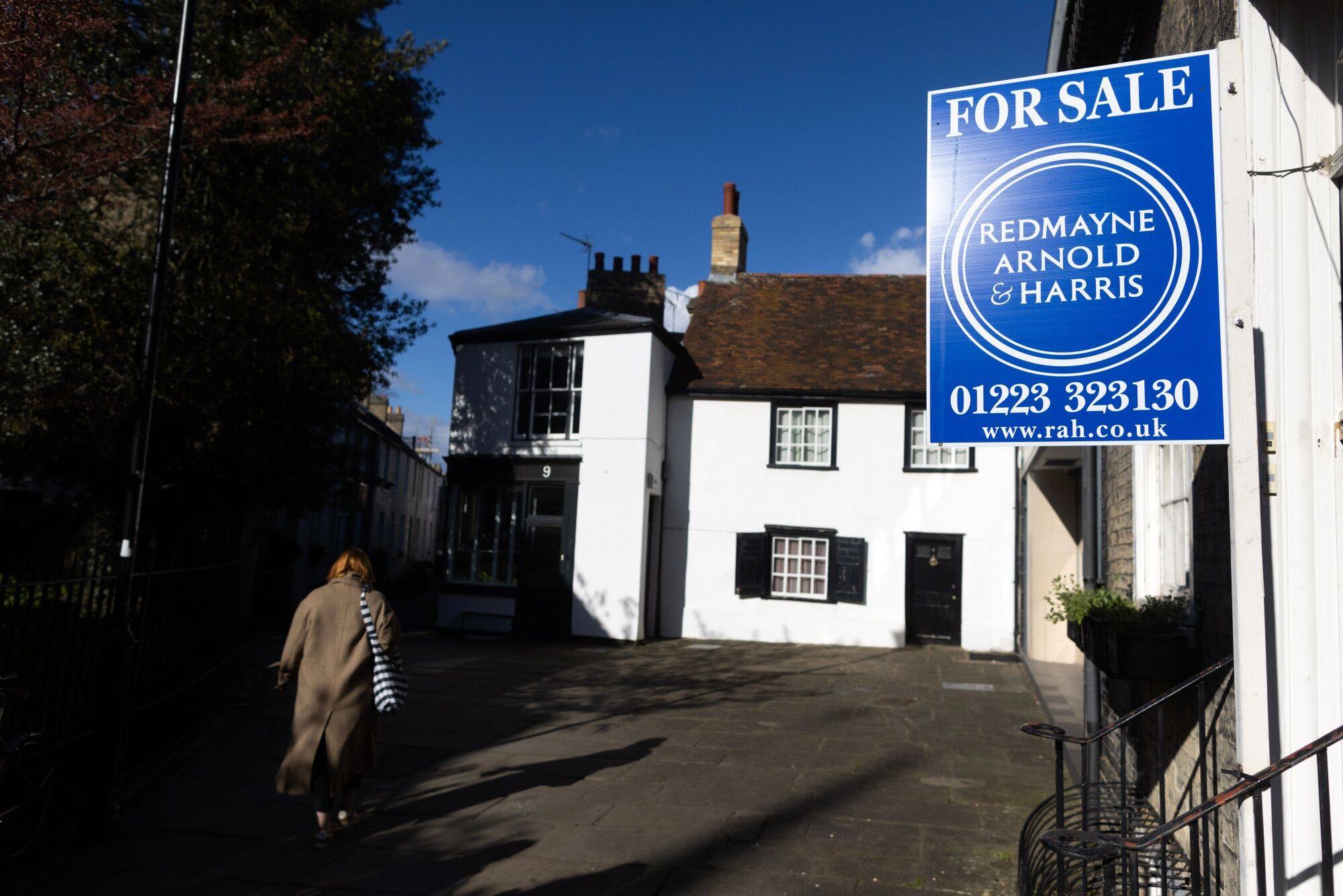 A for sale sign outside a house in Cambridge, UK. Photo: Bloomberg