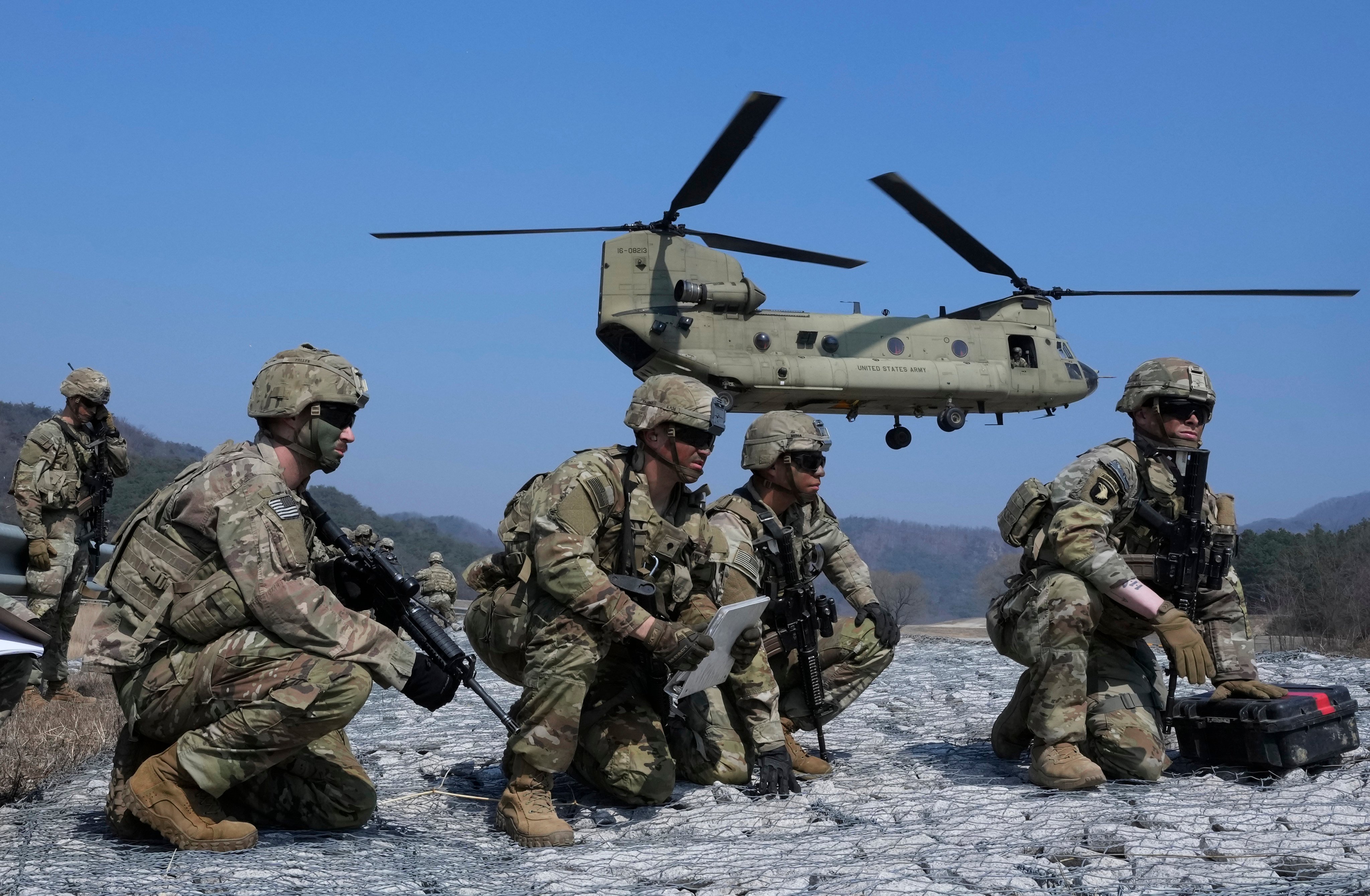 US Army soldiers wait to board their helicopter during a joint military drill between South Korea and the United States at Rodriguez Live Fire Complex in Pocheon, South Korea, on March 19. North Korea launched a short-range ballistic missile toward the sea on Sunday, its neighbours said, ramping up testing activities in response to US-South Korean military drills that it views as an invasion rehearsal. Photo: AP 