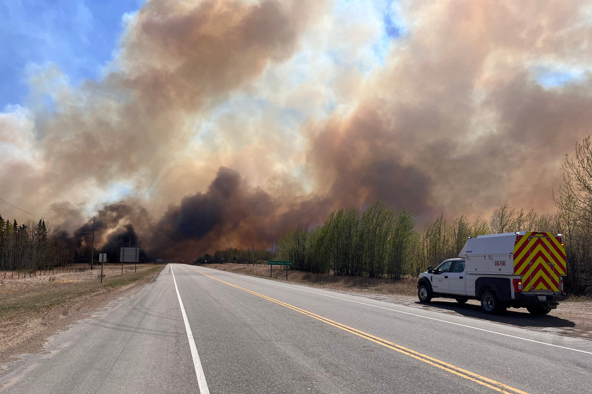 A smoke column rises from a wildfire near Wildwood, Alberta, Canada. Alberta Wildfire/Handout via Reuters