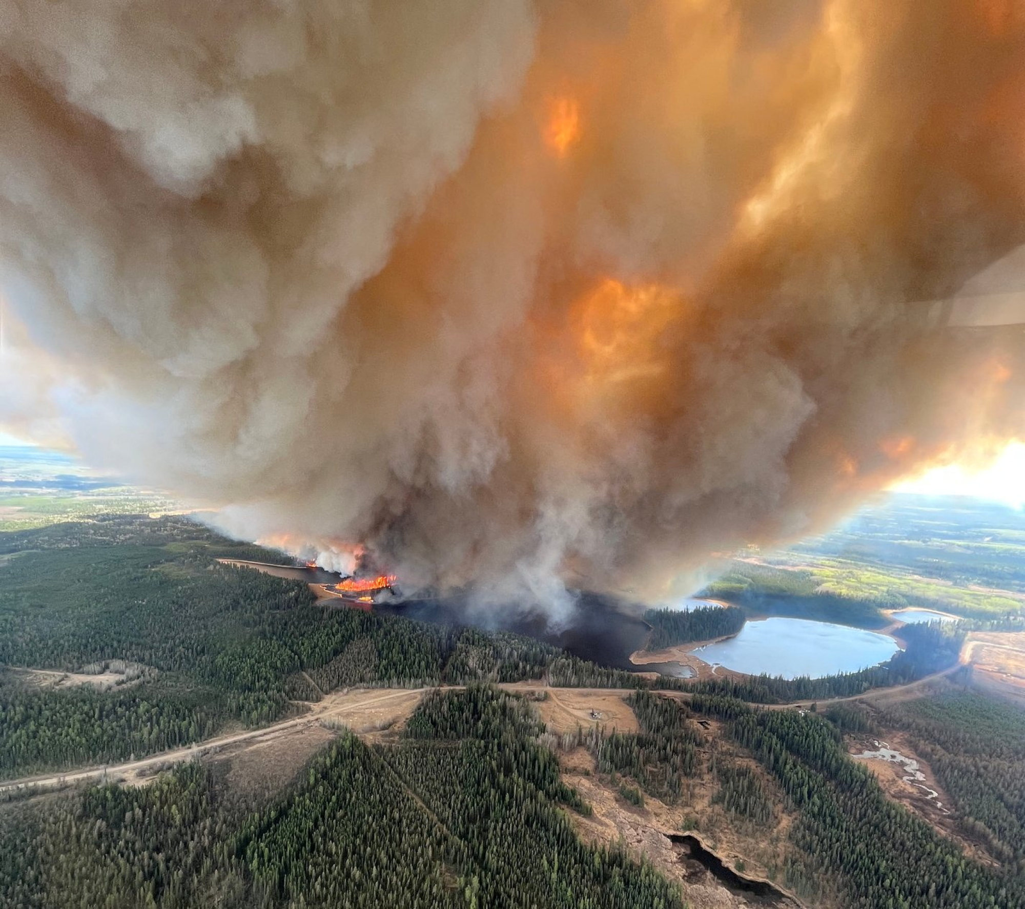 A smoke column rises from a wildfire near Lodgepole, Alberta, Canada. Photo: Alberta Wildfire/Handout via Reuters