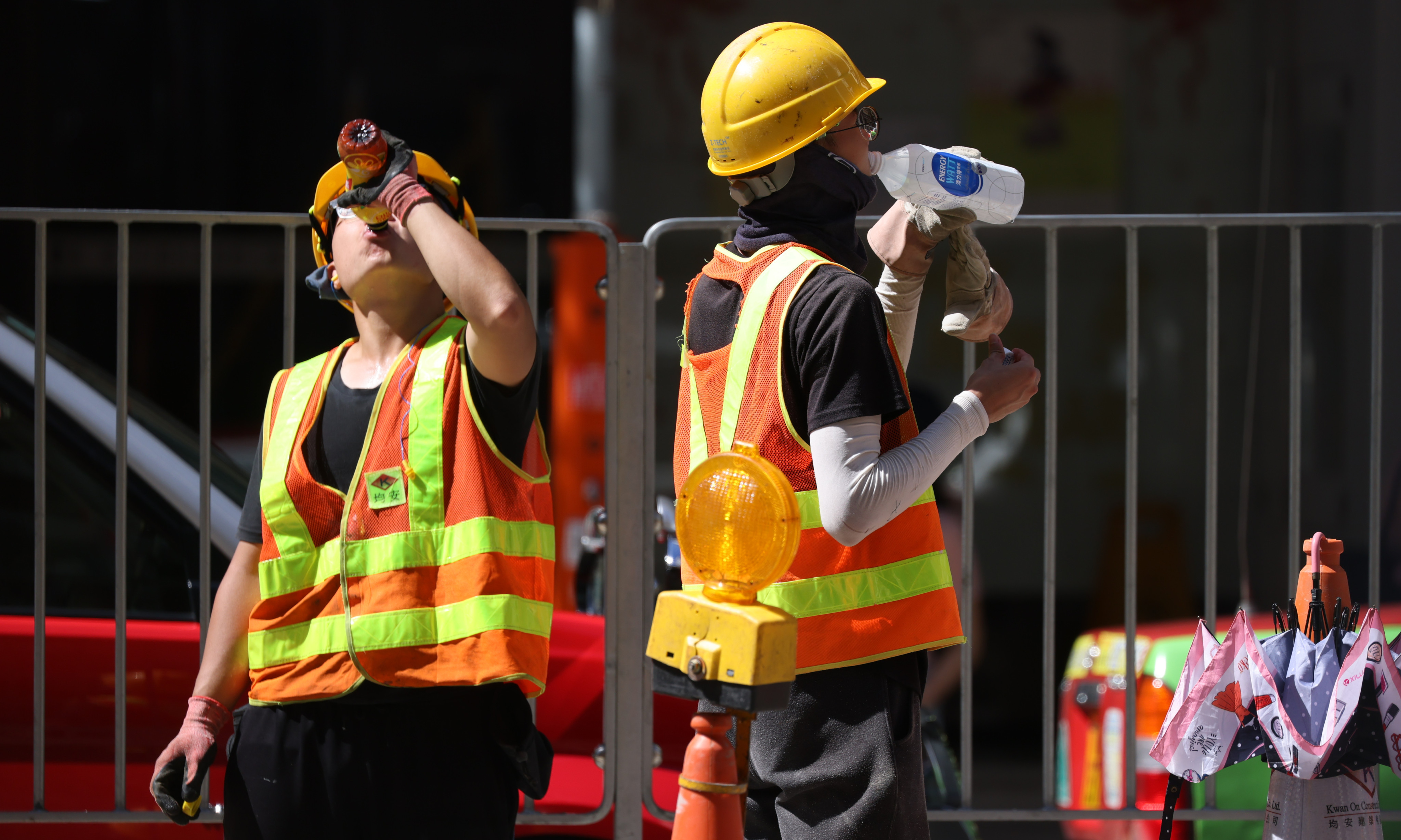 Road workers battle the heat in Wan Chai. Photo: Nora Tam
