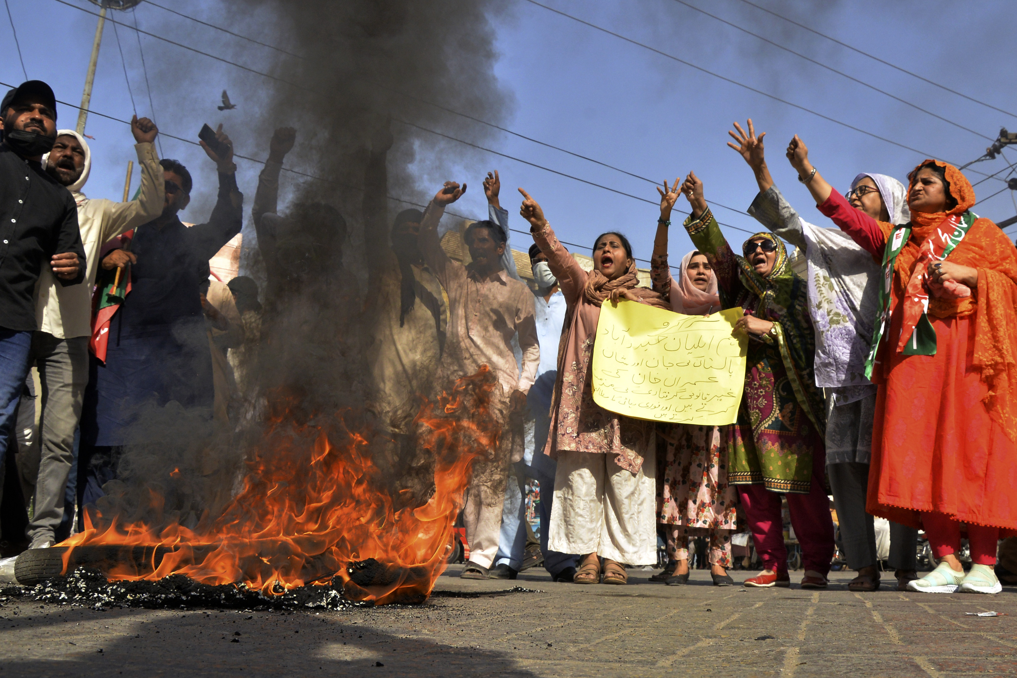 Supporters of Imran Khan in Hyderabad, Pakistan, chant slogans next to burning tyres to condemn his arrest. Photo: AP
