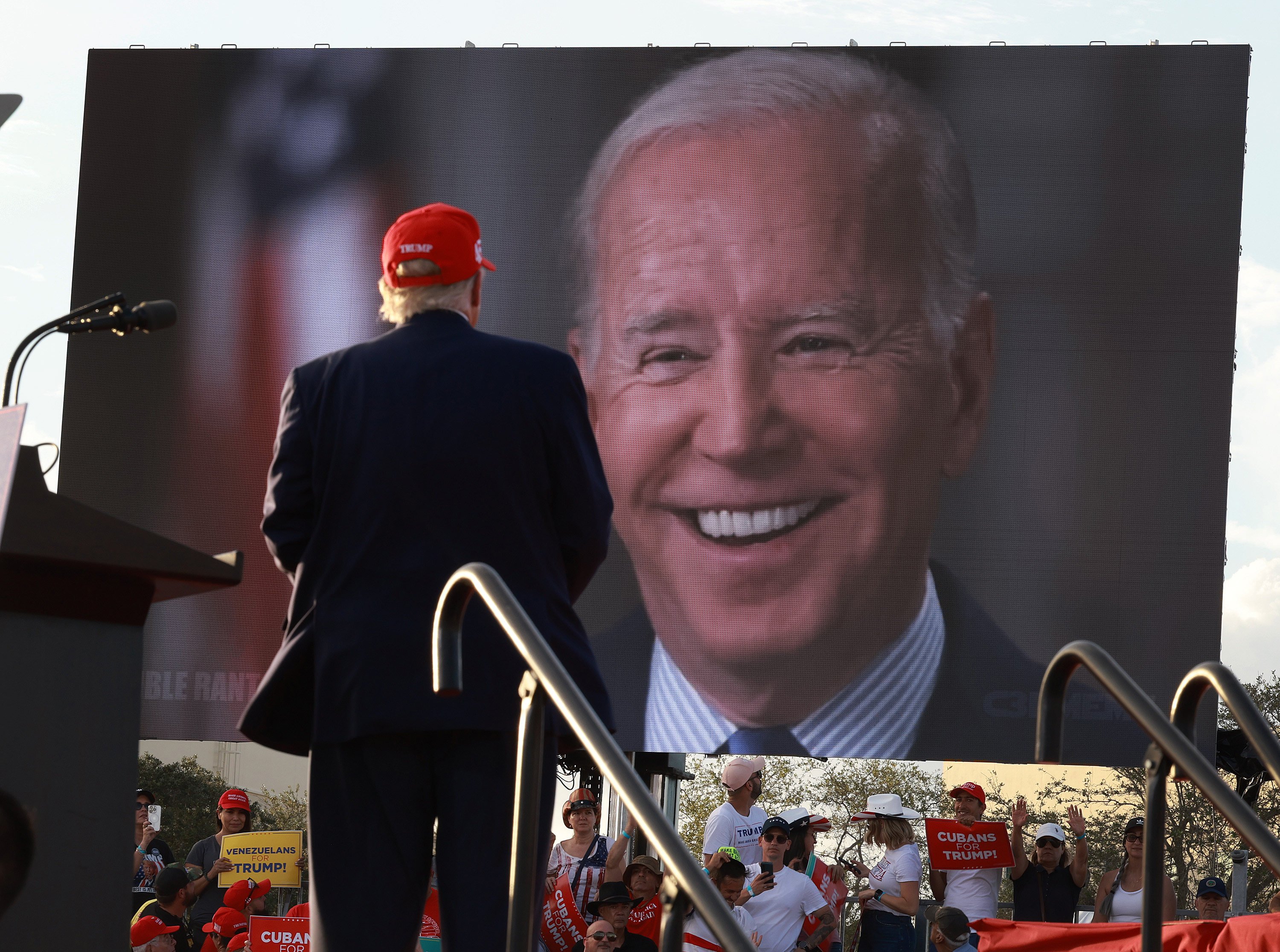 Former president Donald Trump watches a video of US President Joe Biden playing during a rally for Senator Marco Rubio at the Miami-Dade Country Fair and Exposition on November 6, 2022. Despite the wishes of many Americans, the 2024 presidential election could come down to a rematch between Biden and Trump. Photo: TNS