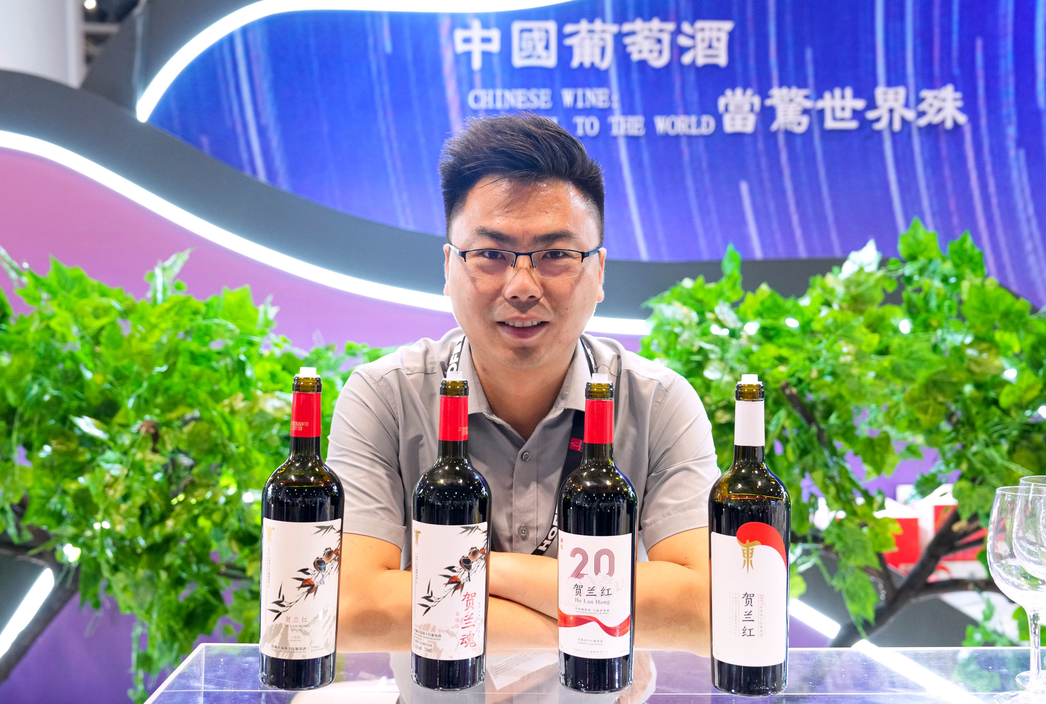 Lu Yongliang, a senior official at Helan Hong Winery,  Ningxia, shows off its products at a major trade show in Hong Kong. Photo: Elson Li