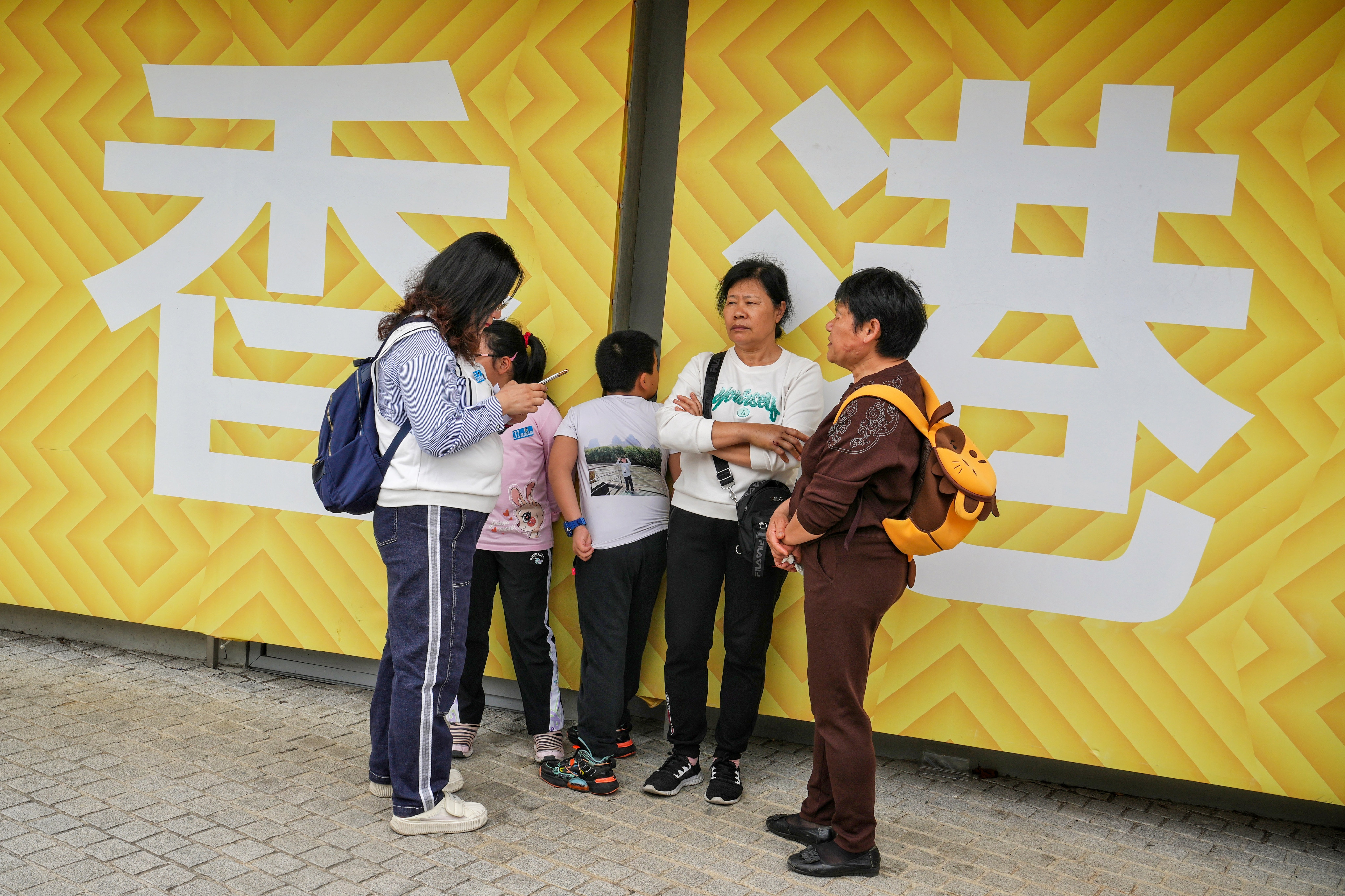 Tourists wait for their bus outside the Hong Kong Palace Museum. Photo: Elson Li