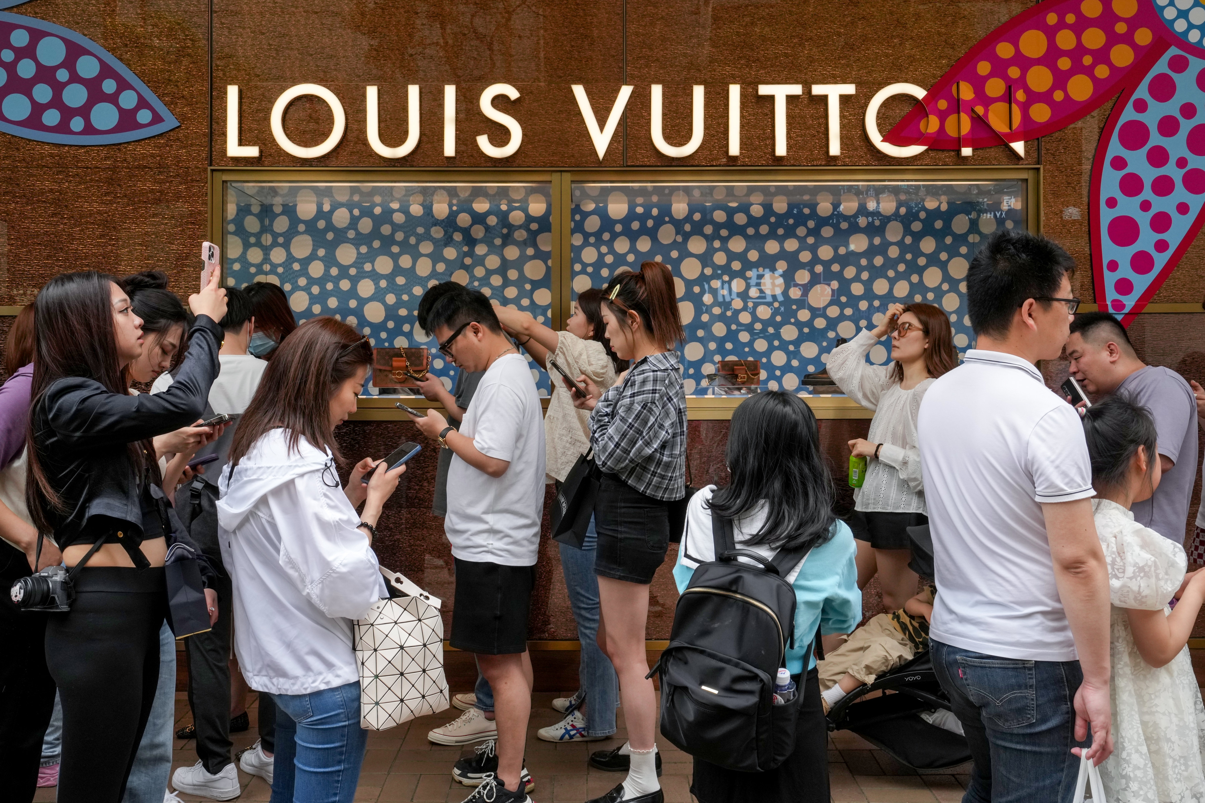 Tourists queue up outside luxury goods stores along Canton Road in Tsim Sha Tsui. Photo: Elson Li