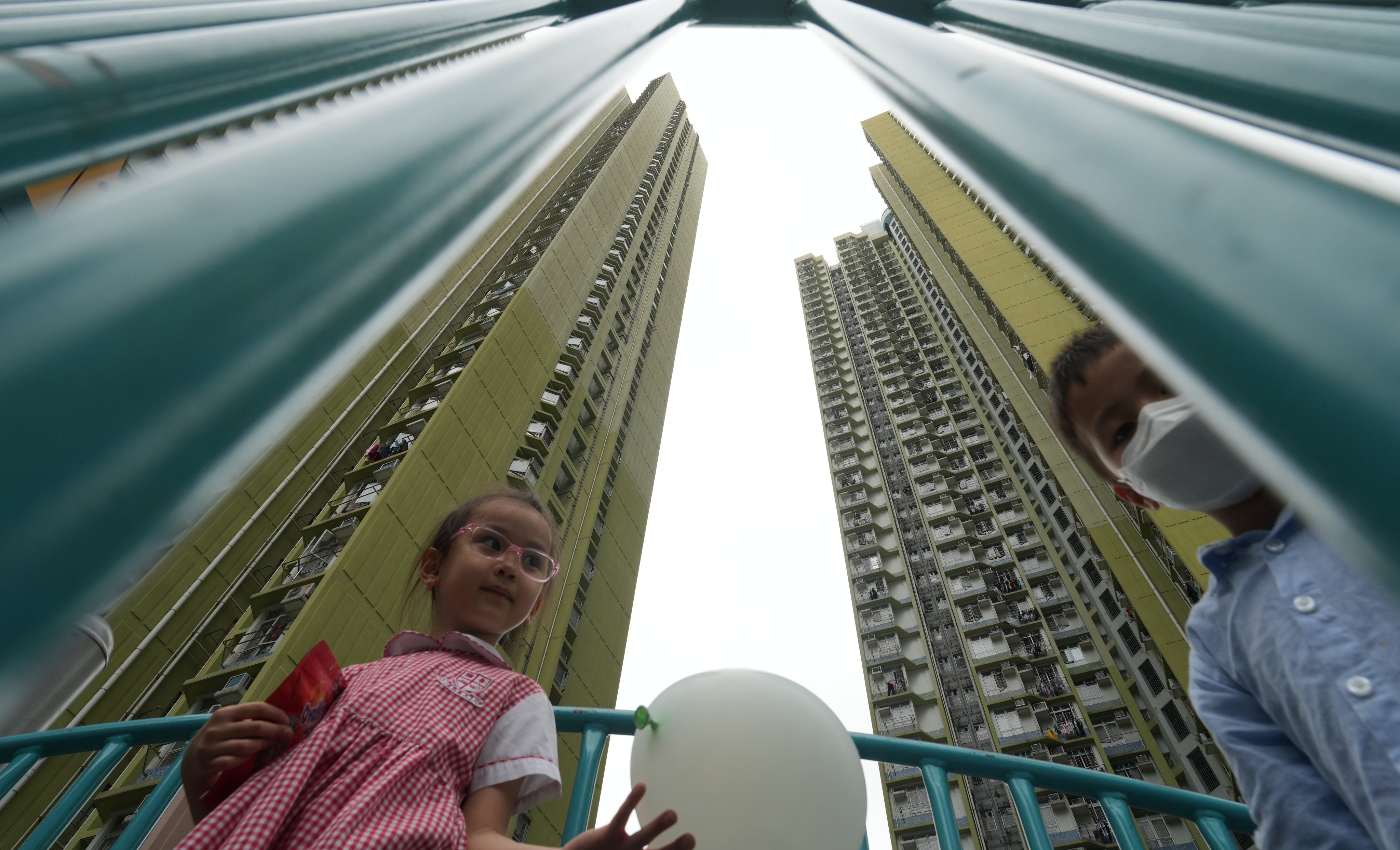 Children play at a public housing estate in Cheung Sha Wan on May 11. The increased supply of subsidised housing offers a competitive alternative to small flats in the private housing market. Photo: Sam Tsang