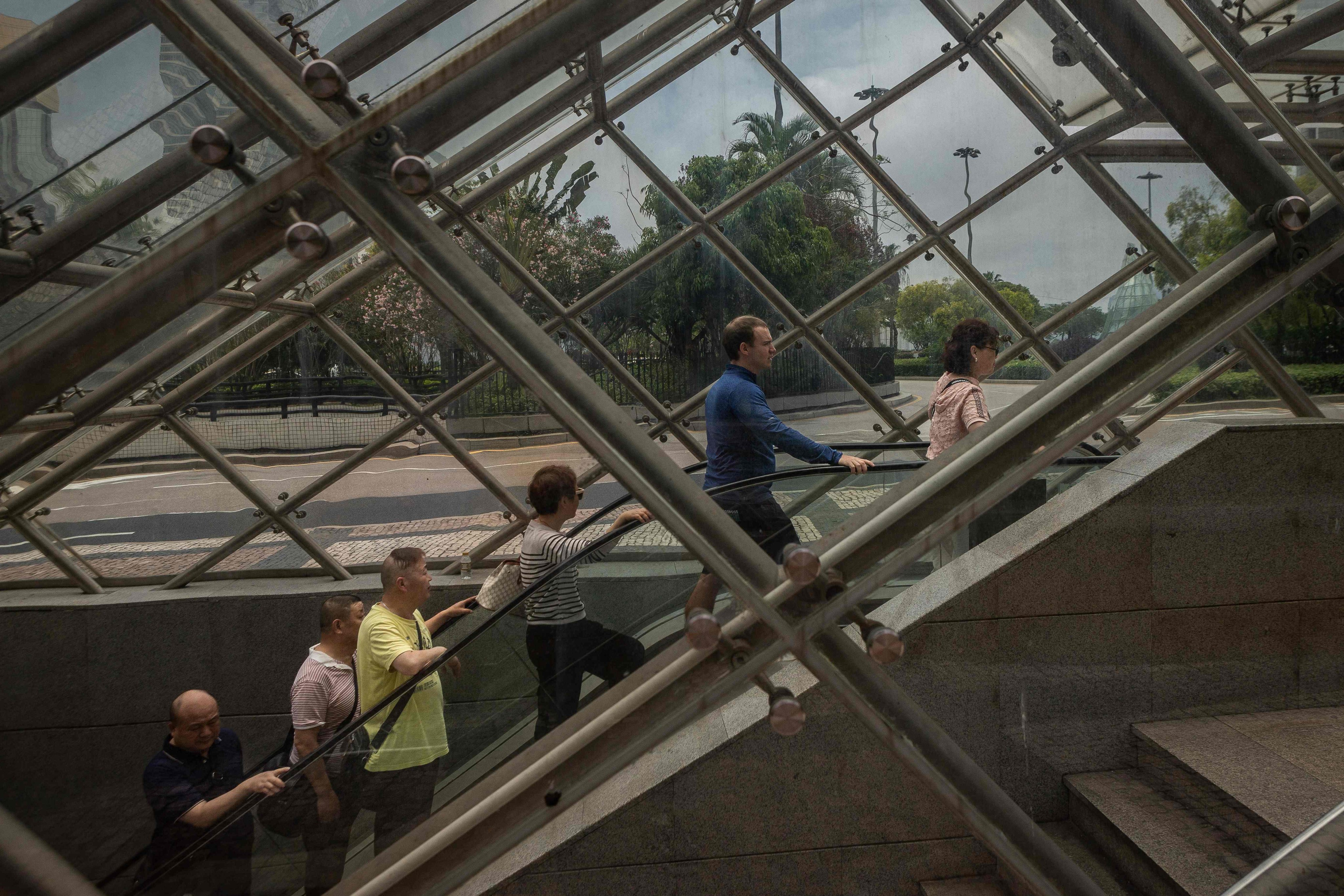 People use an escalator during the Golden Week holiday in Macau on May 3, 2023. Photo: AFP