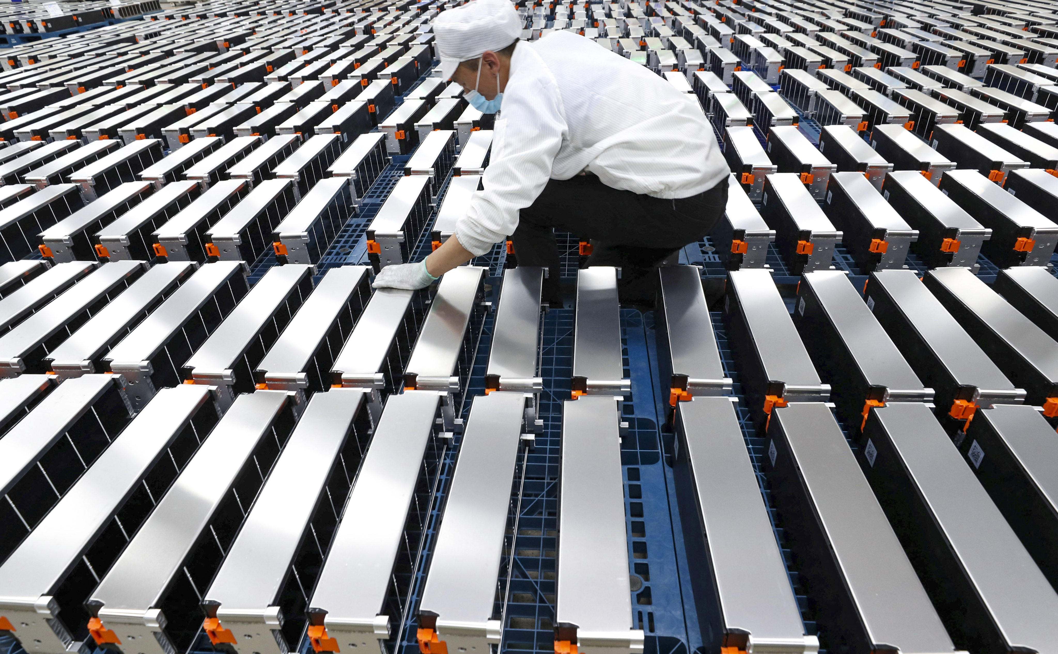 A worker inspects batteries at a Xinwangda Electric Vehicle Battery factory in Nanjing, Jiangsu province, in March 2021. Photo: AFP