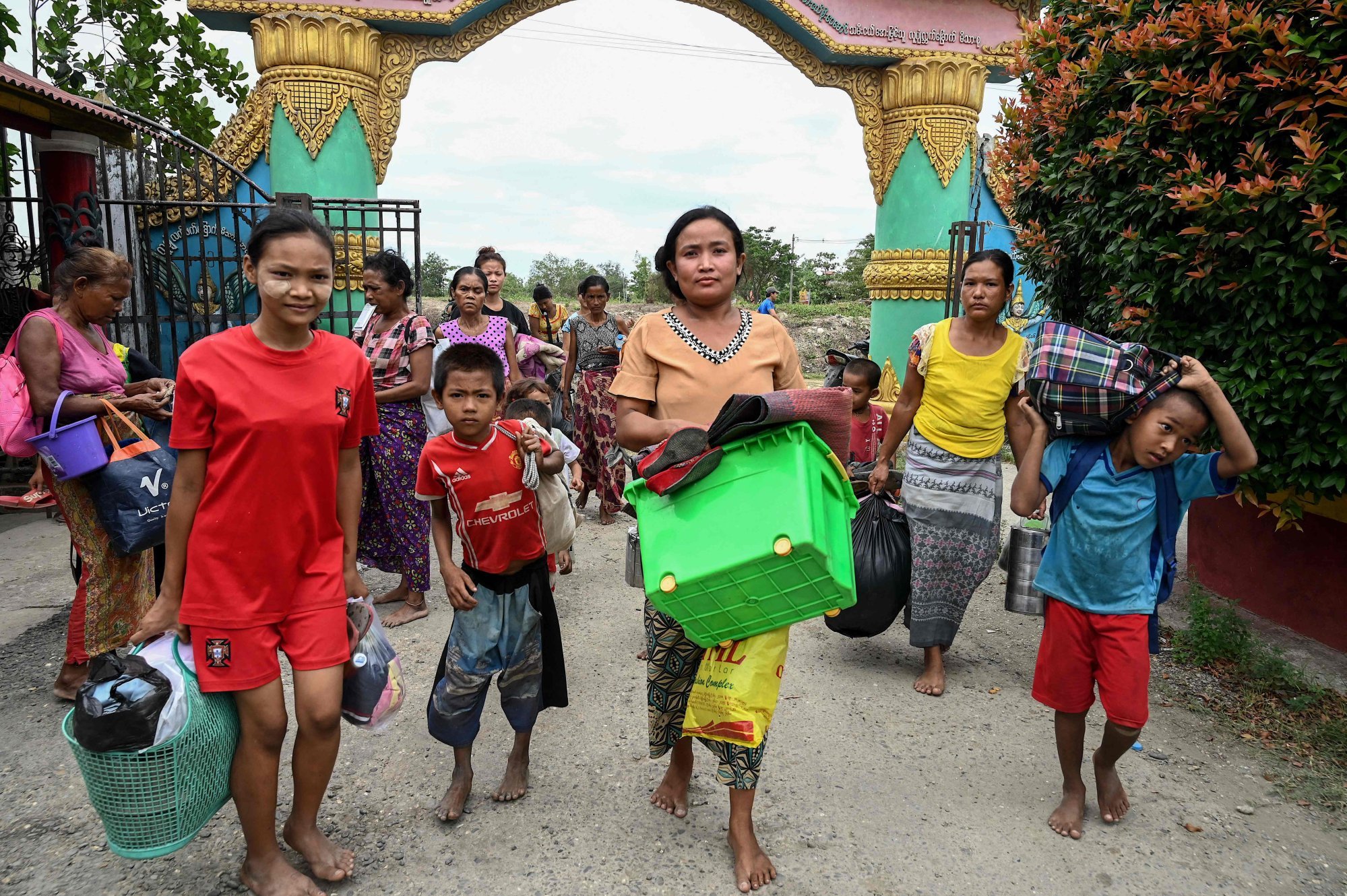 People arrive to take shelter at a monastery in Sittwe town in Myanmar, before Cyclone Mocha is forecast to make landfall on May 14 along the Bangladesh-Myanmar border. Photo: AFP