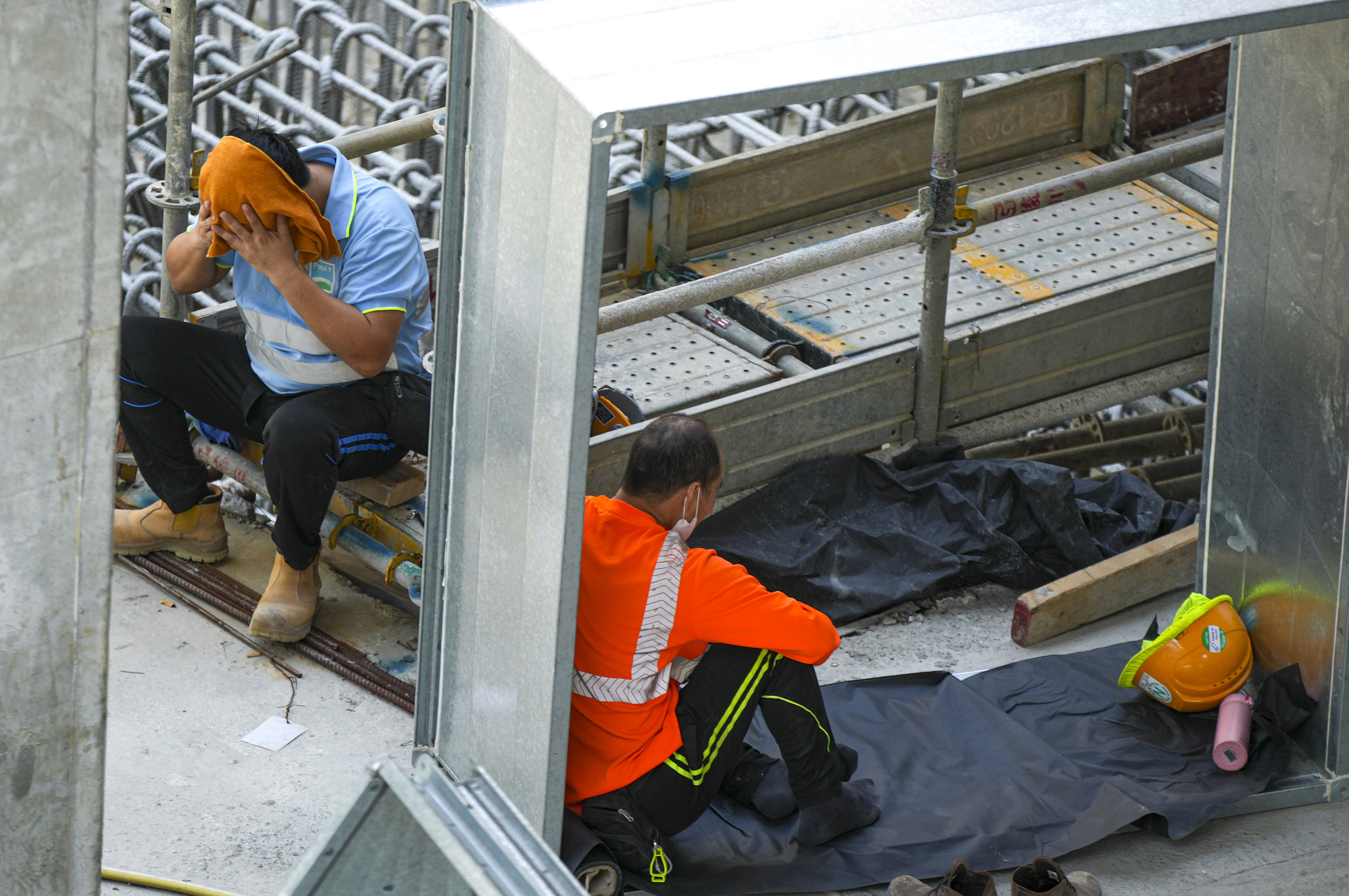 Workers rest at a construction site in West Kowloon. Photo: Sam Tsang
