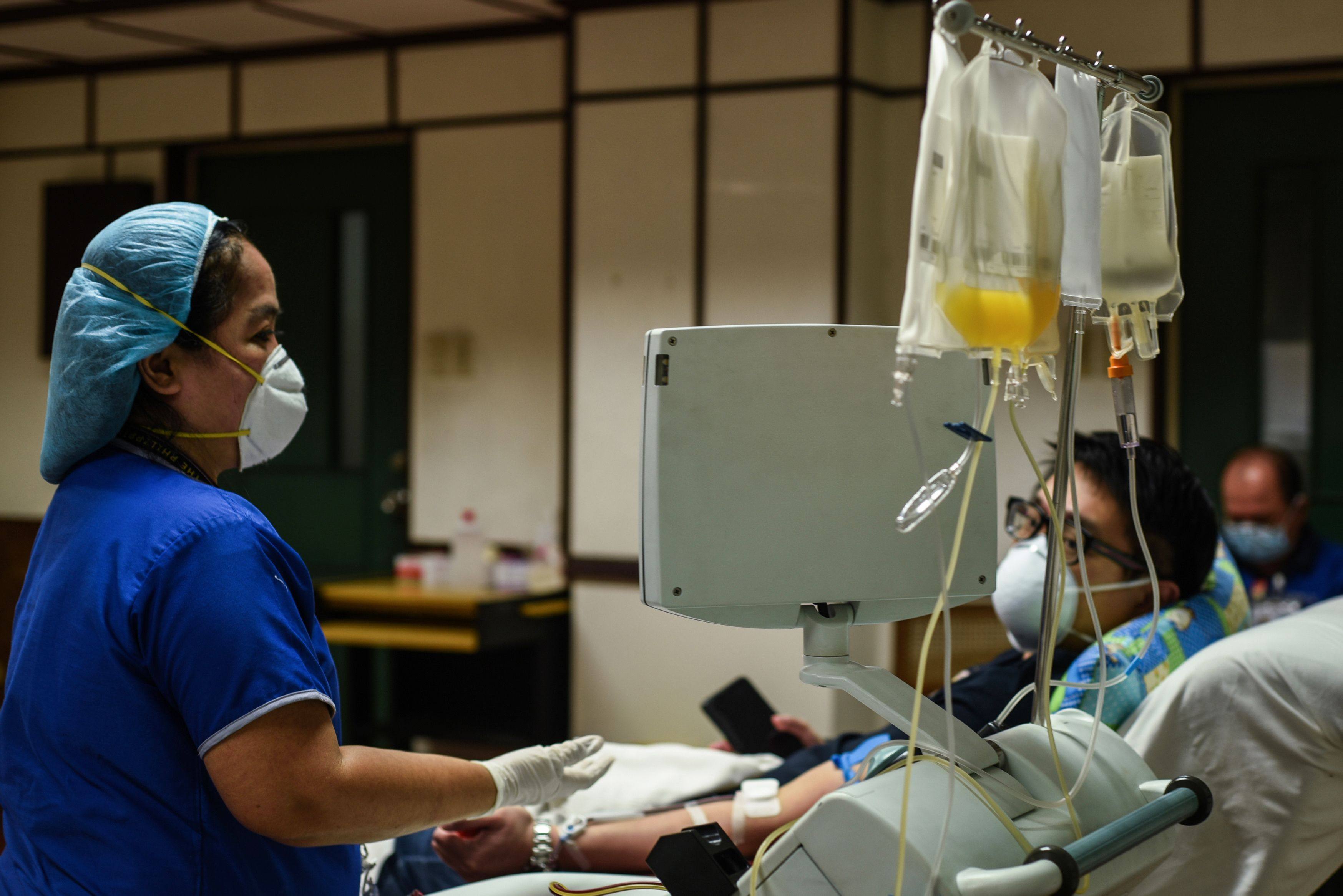 A nurse checks on a patient at a hospital in Manila. Photo: AFP 
