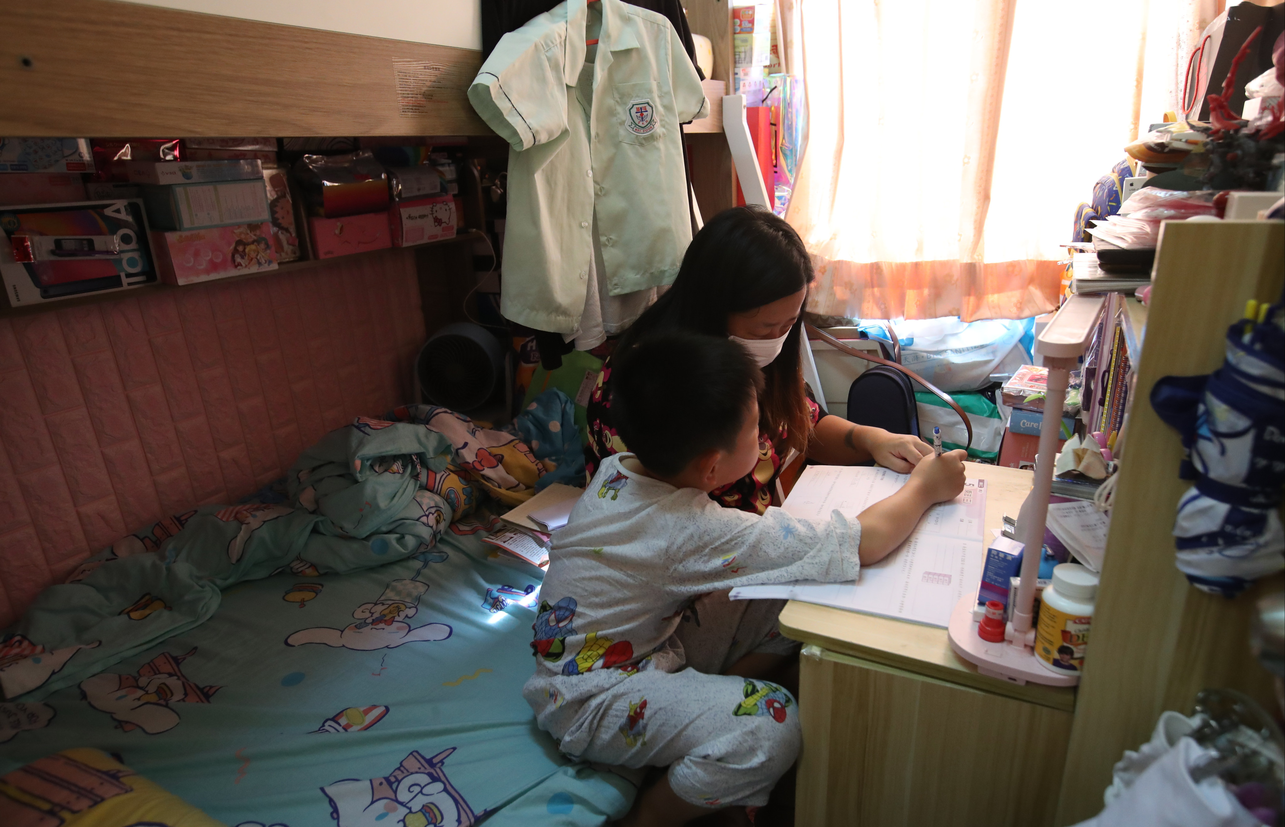 A mother with her son in a subdivied flat in Hong Kong. Photo: Edmond So