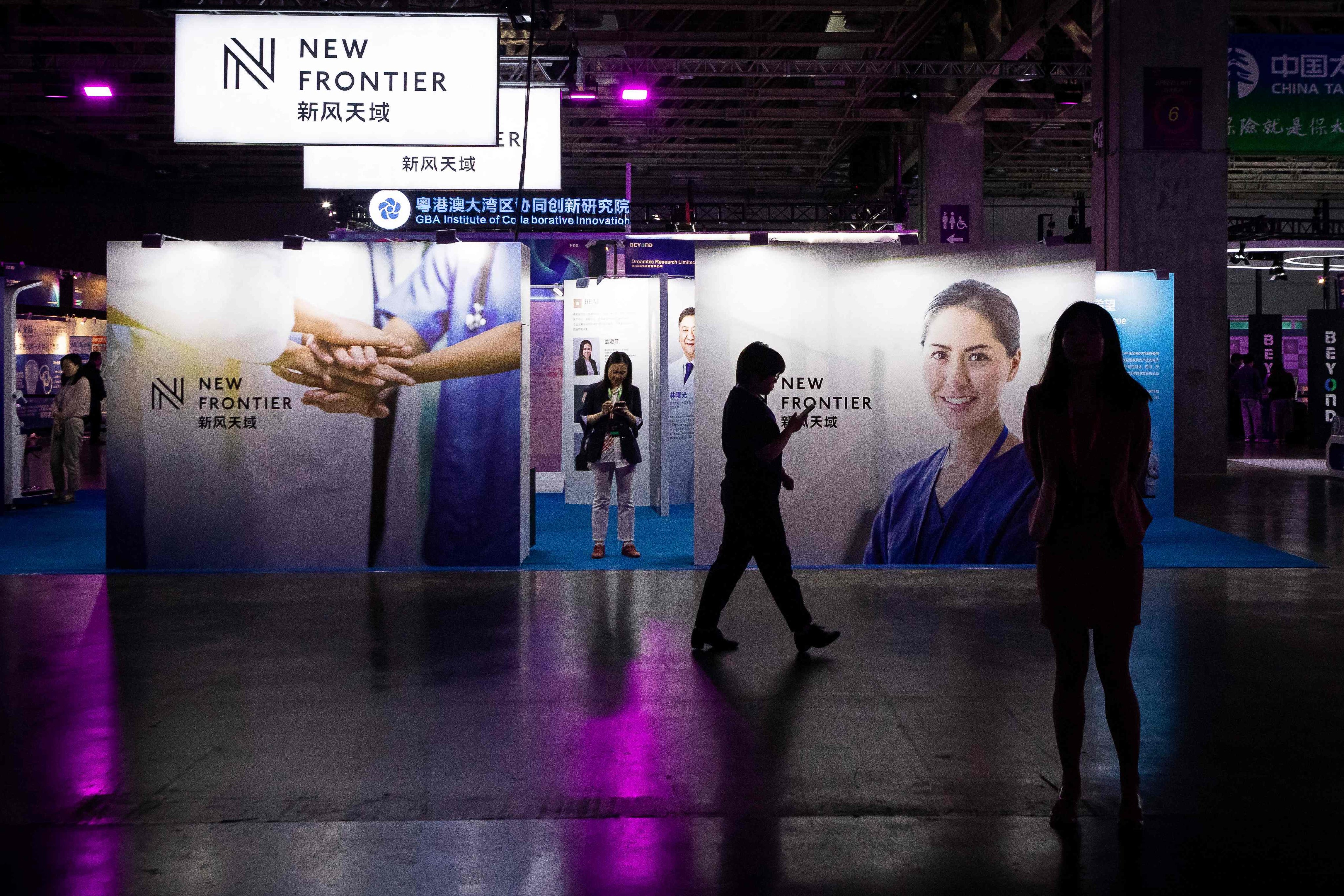 Visitors walk past a stand at the Beyond Expo tech conference in Macau on May 10. Photo: AFP