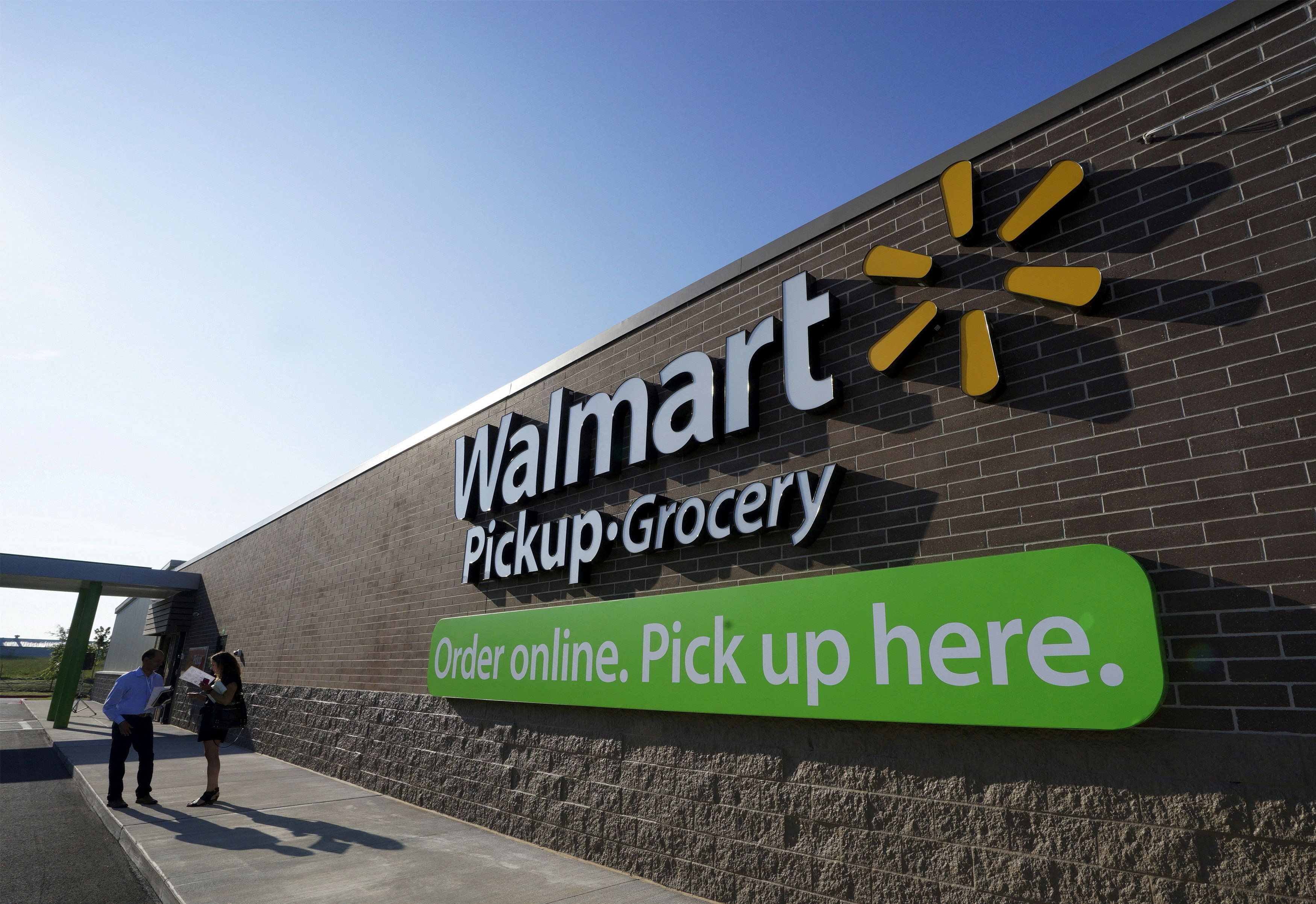 People talk outside a Walmart store in Bentonville, Arkansas, on May 5. The retail giant sells more than half of all groceries in some areas of the US. Photo: Reuters