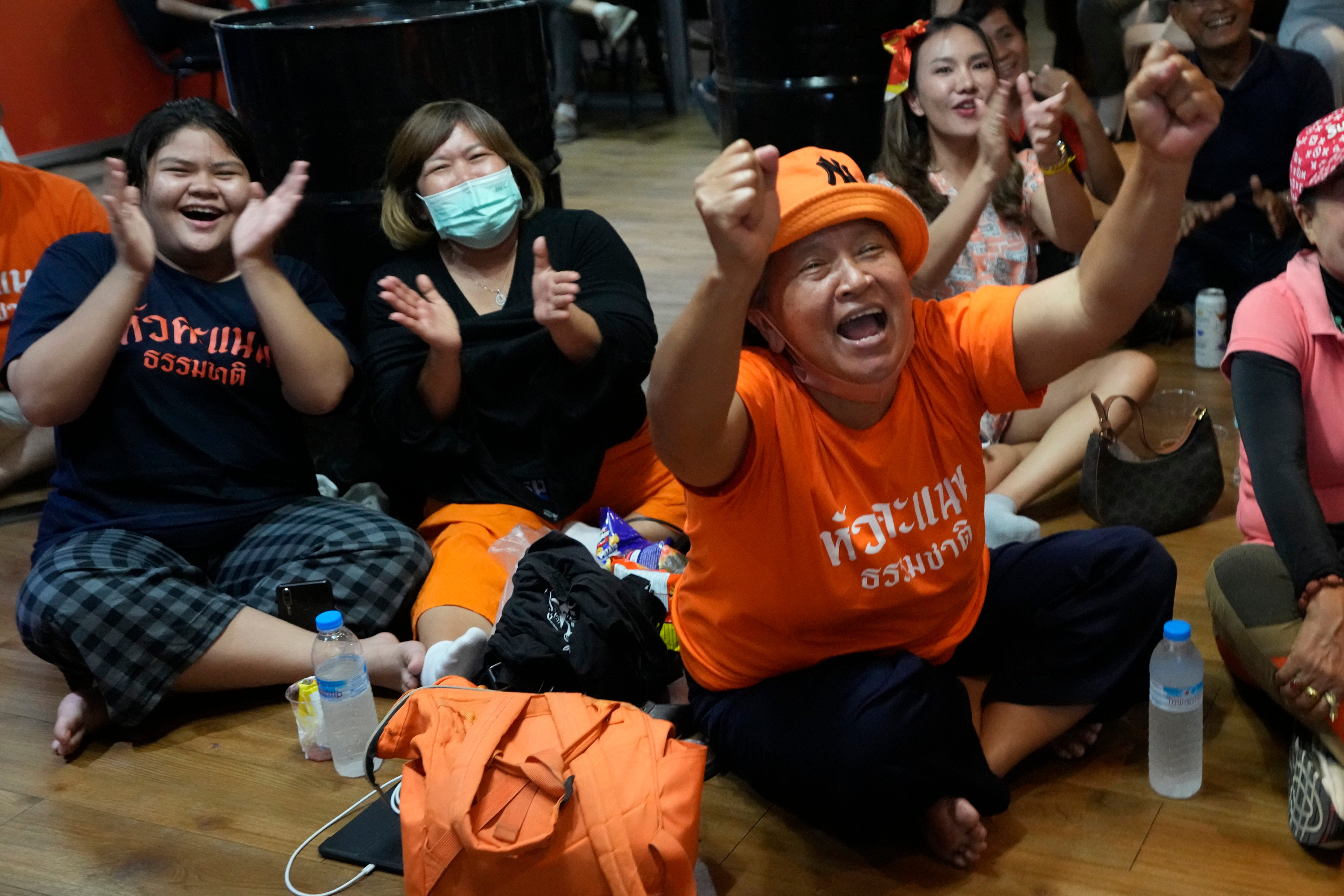 Supporters of the Move Forward Party cheer as they watch the counting of votes on television after Sunday’s election. Photo: AP