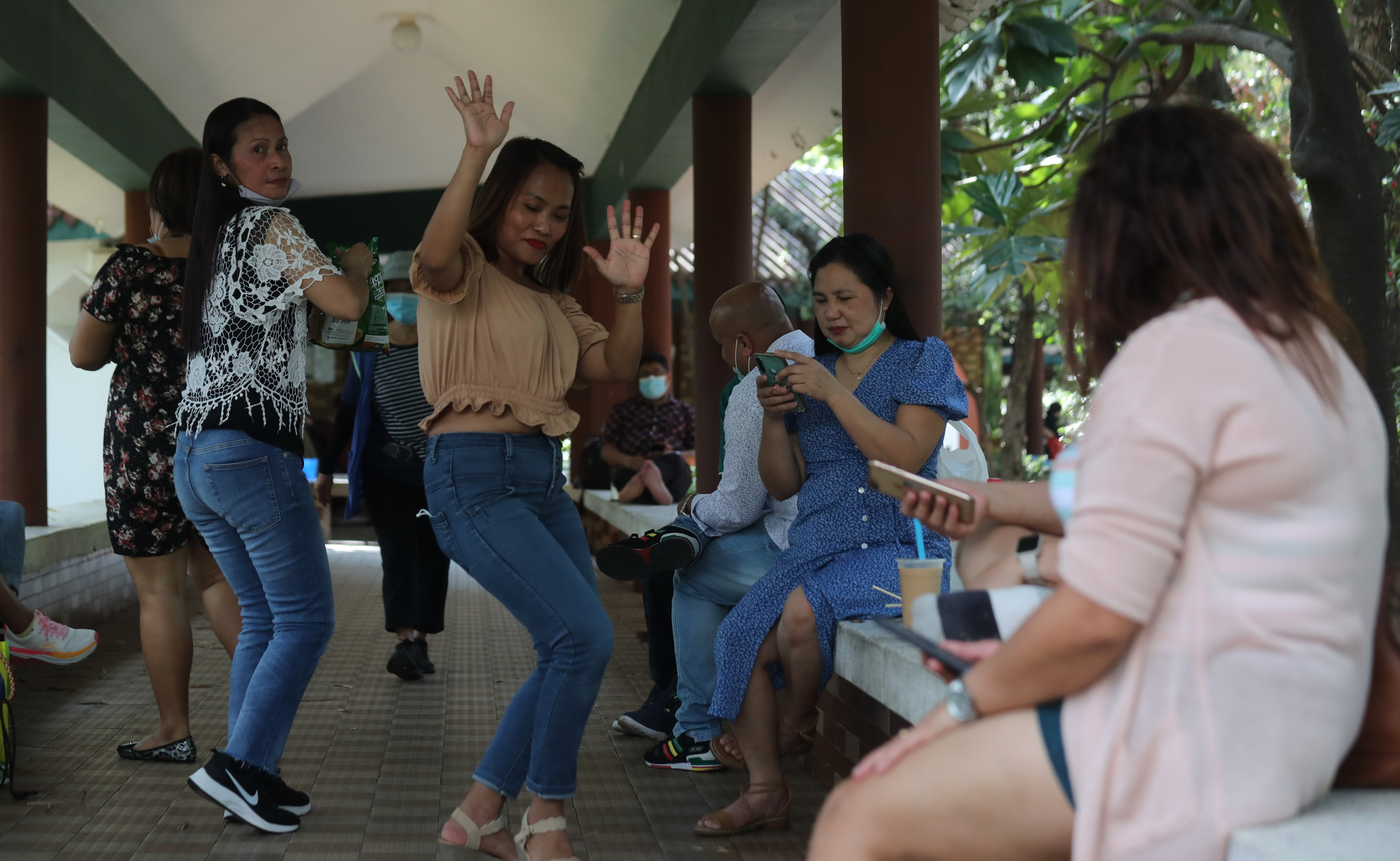 Domestic helpers enjoy a light-hearted moment on their off day in Tsim Sha Tsui. Photo: Xiaomei Chen
