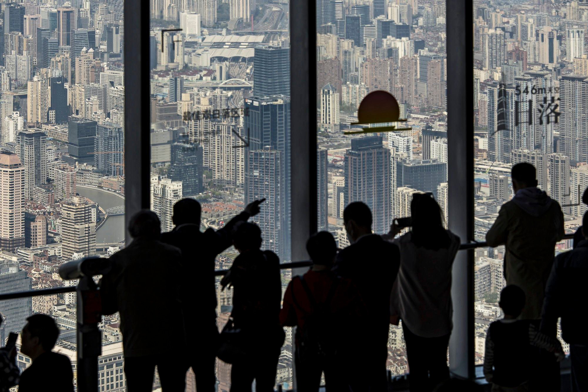 Visitors take in the view from the observation deck at Shanghai Tower. Home sales have been strong in the Greater Bay Area, the Yangtze River Delta area and the Beijing-Tianjin-Hebei region, thanks to demand in tier-1 cities such as Shanghai and Shenzhen. Photo: Bloomberg